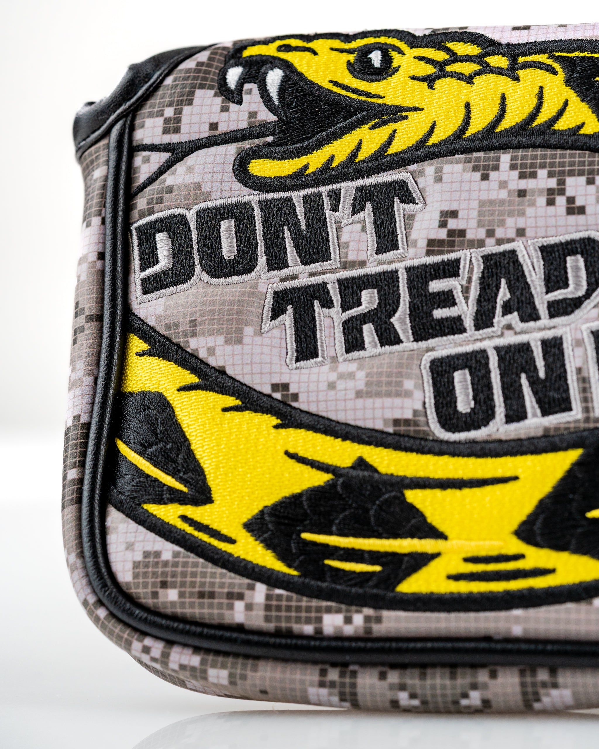 Don't Tread On Me 2.0 mallet putter cover featuring a bold yellow snake design on a camouflage background.