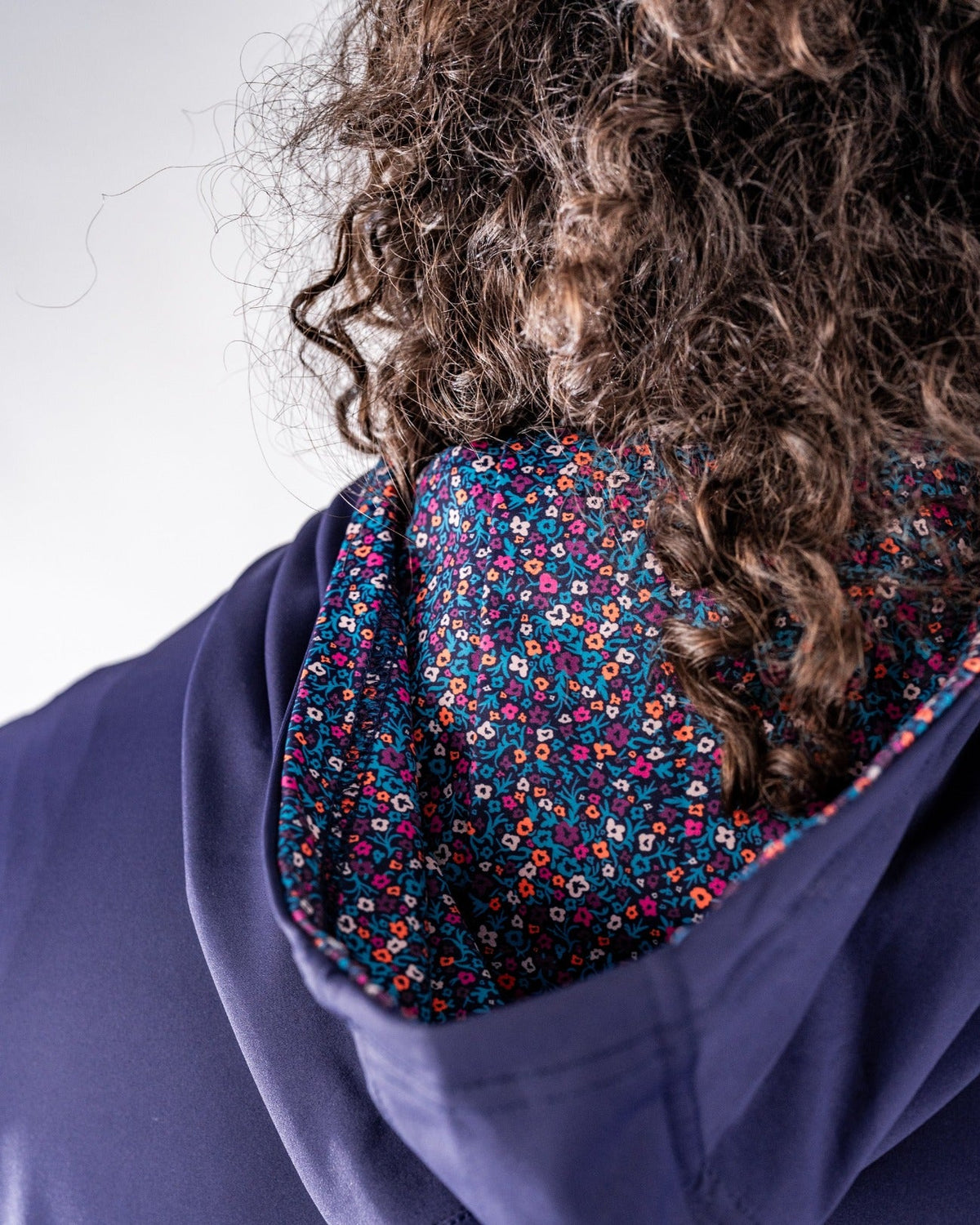Lavender golf hoodie featuring a vibrant floral pattern on the interior lining, designed for stylish performance on the course.