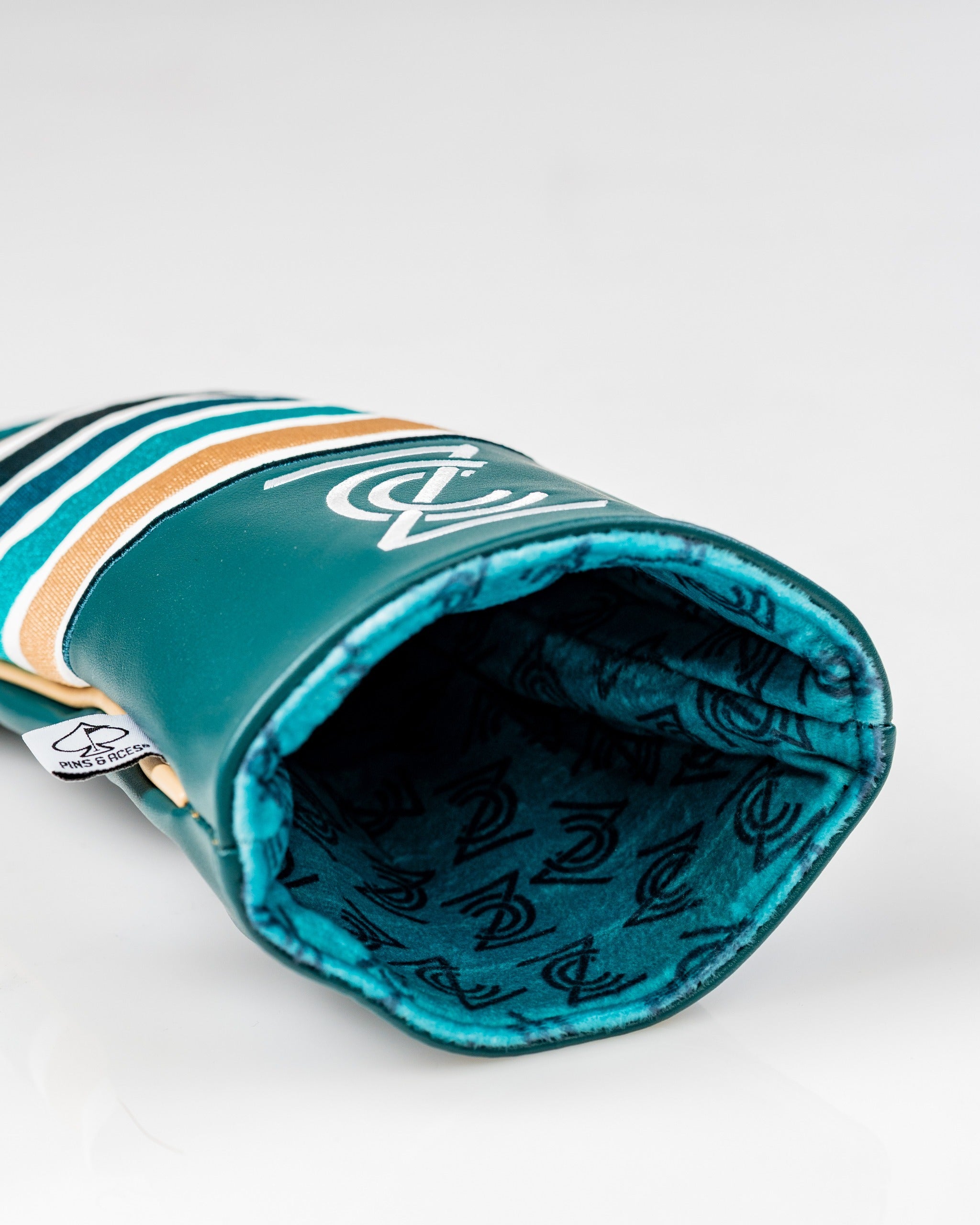 Bold driver cover featuring a vibrant teal design with stripes and a logo, perfect for golfers wanting to stand out.