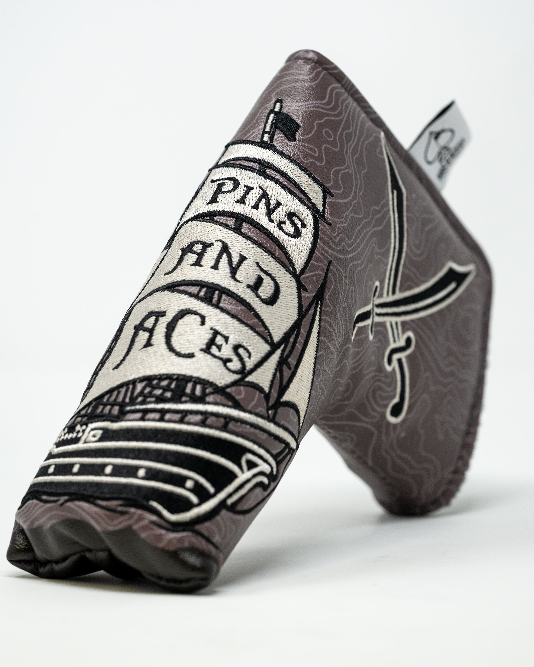 Pirate-themed blade putter cover featuring a skull and crossbones design with a colorful pirate motif.