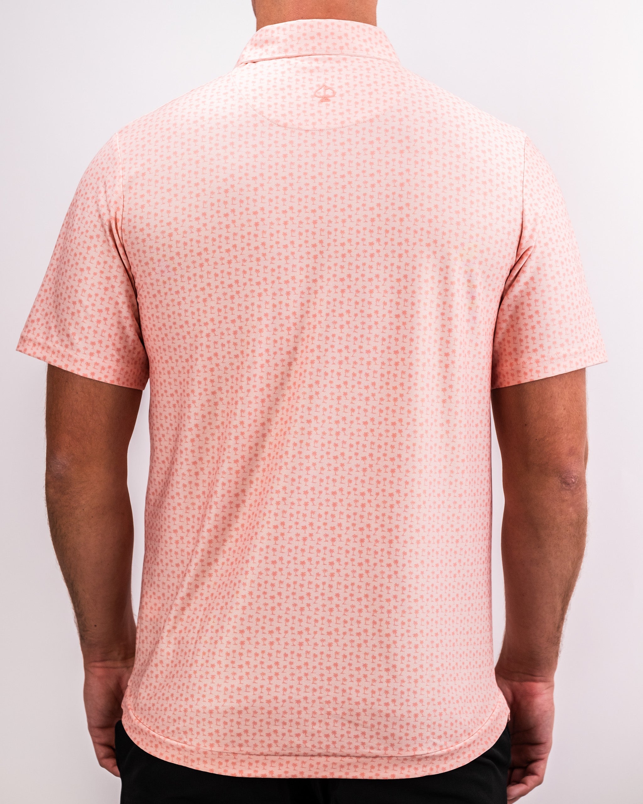 Player Preferred™ Polo in Coral Palms featuring a vibrant tropical palm print design.