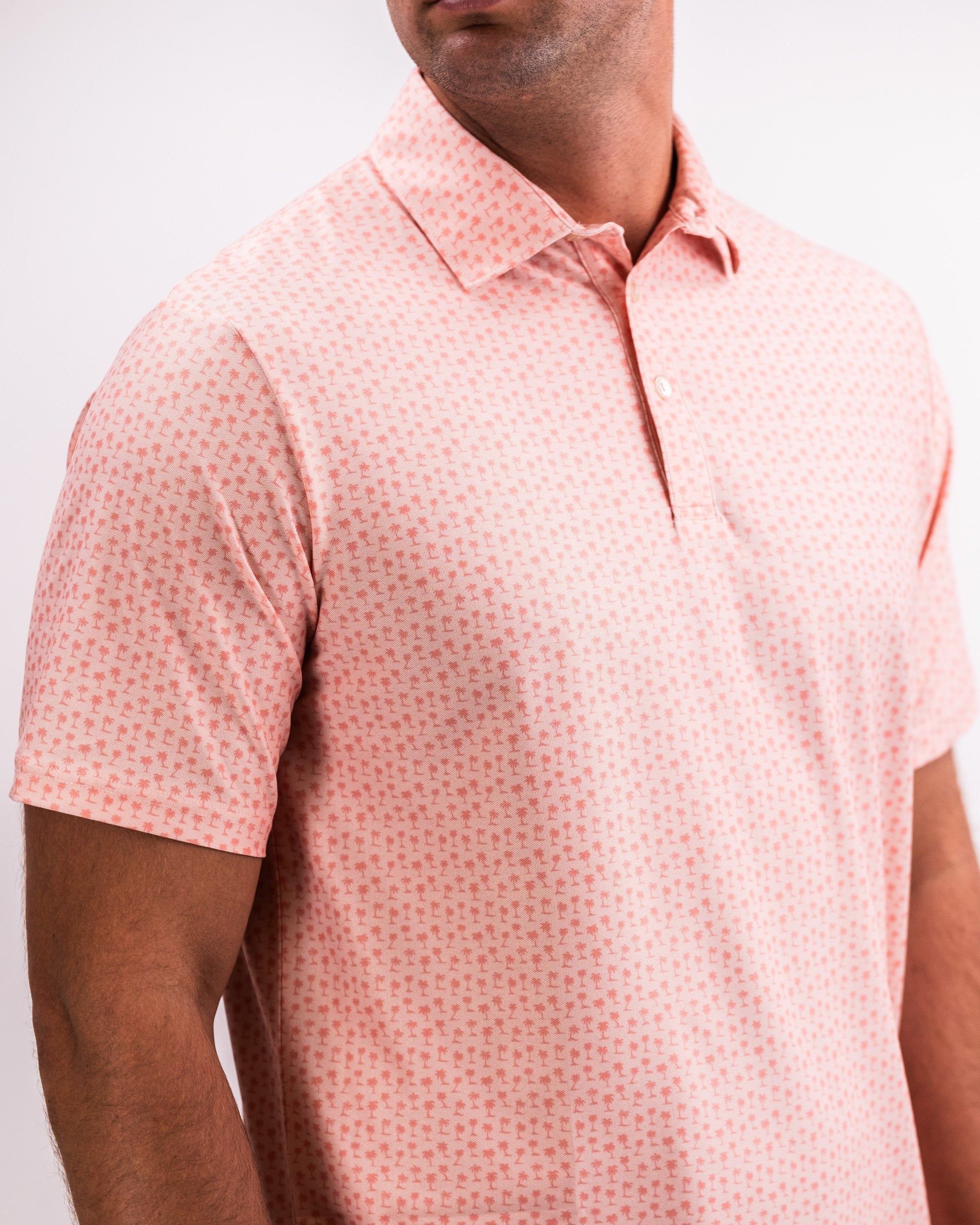 Player Preferred™ Polo in Coral Palms featuring a vibrant tropical print, short sleeves, and a classic collar.