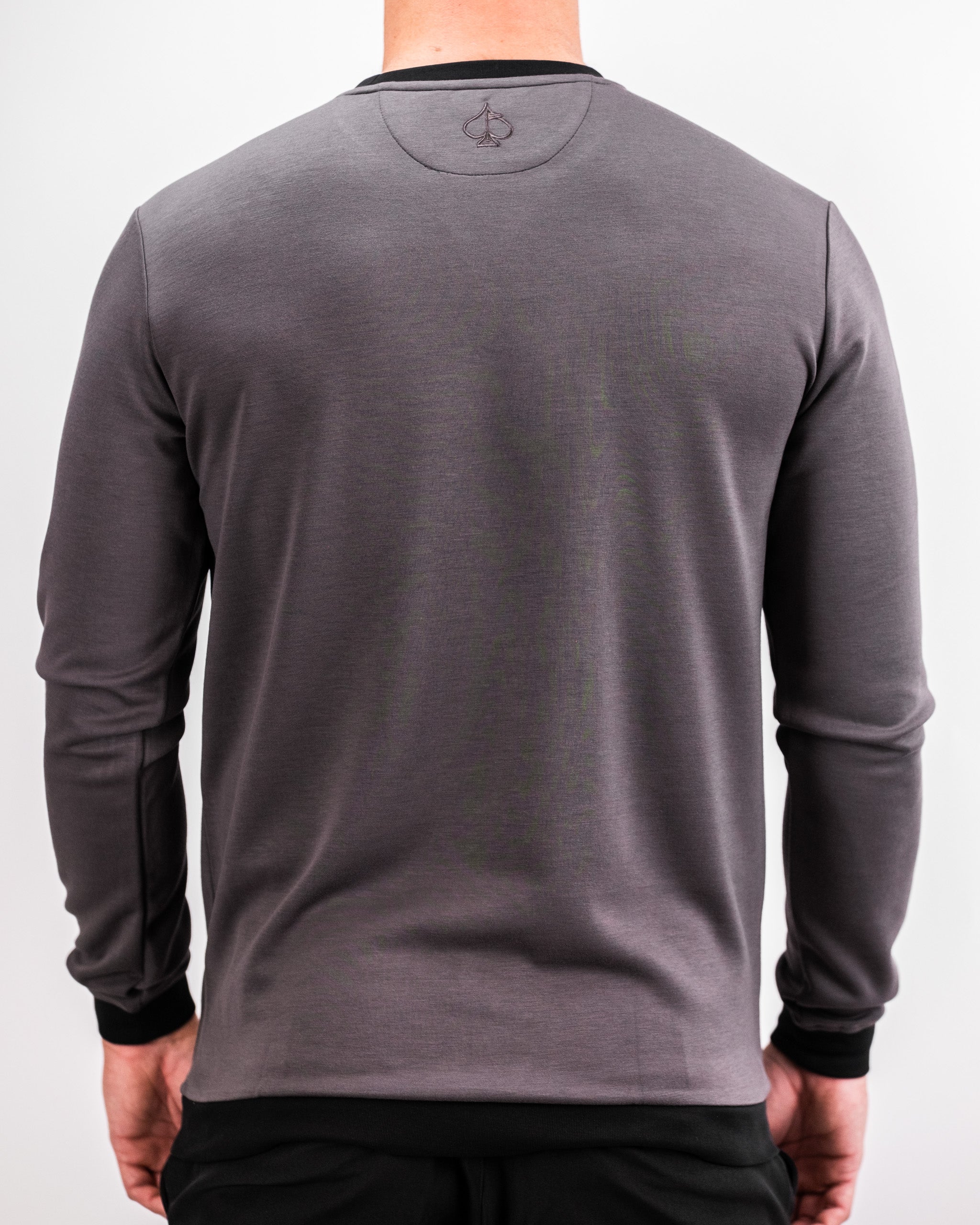Back view of a person wearing a slate grey Player Preferred™ Crewneck sweatshirt with black accents, shown against a plain background.
