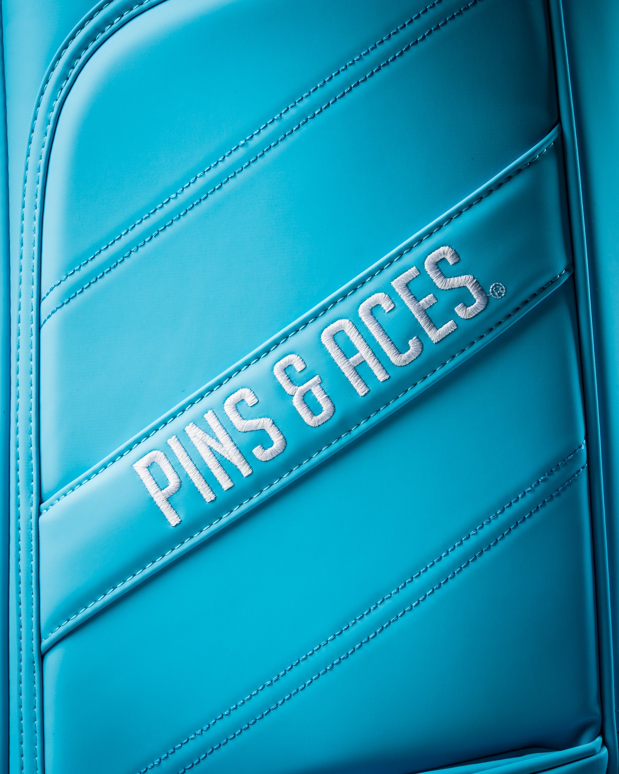 Bright blue Player Preferred Golf Bag from Pins and Aces featuring sleek design and embroidered logo for stylish golfers.