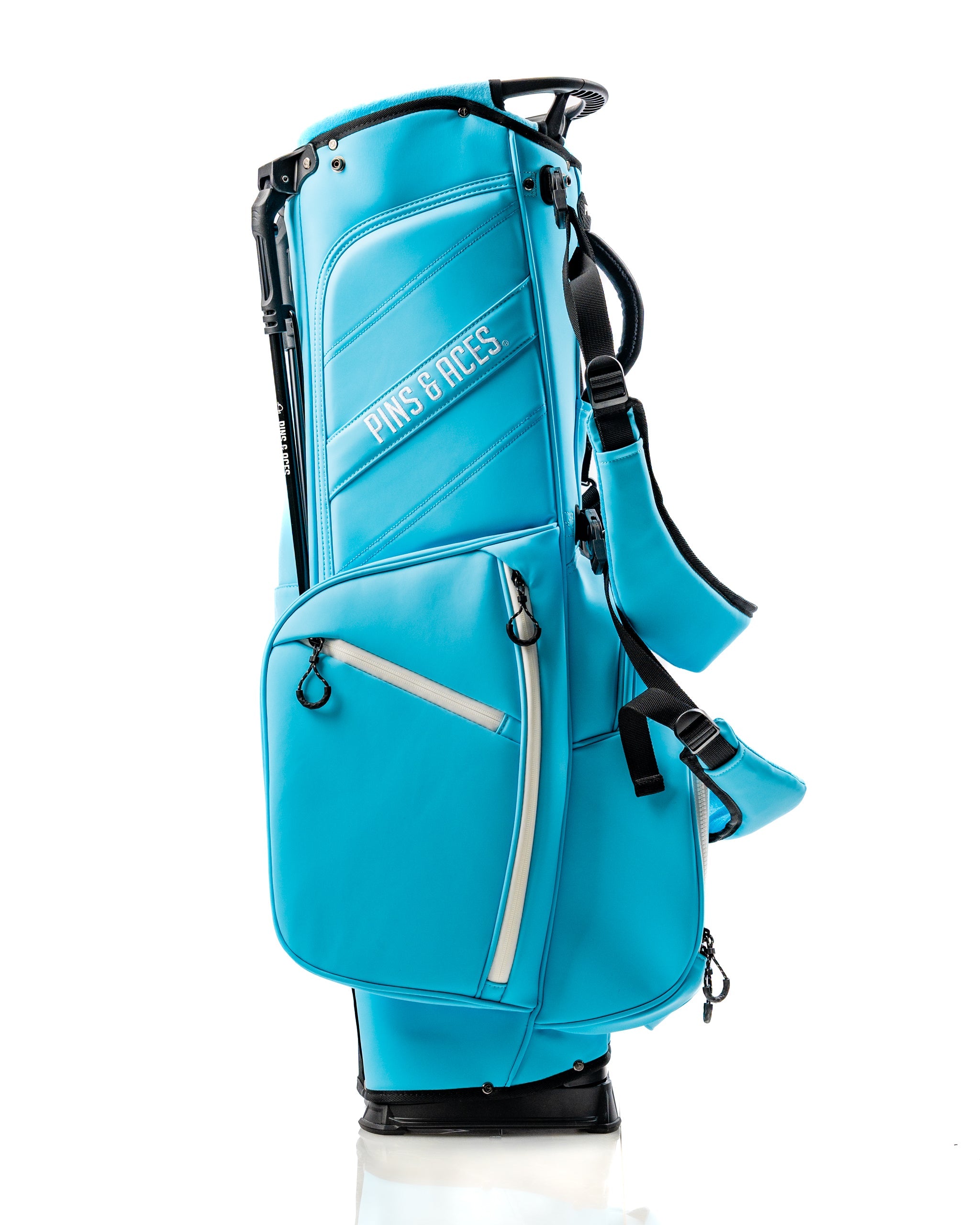 Bright blue Player Preferred Golf Bag from Pins & Aces, featuring multiple pockets and a sleek design for stylish golfers.