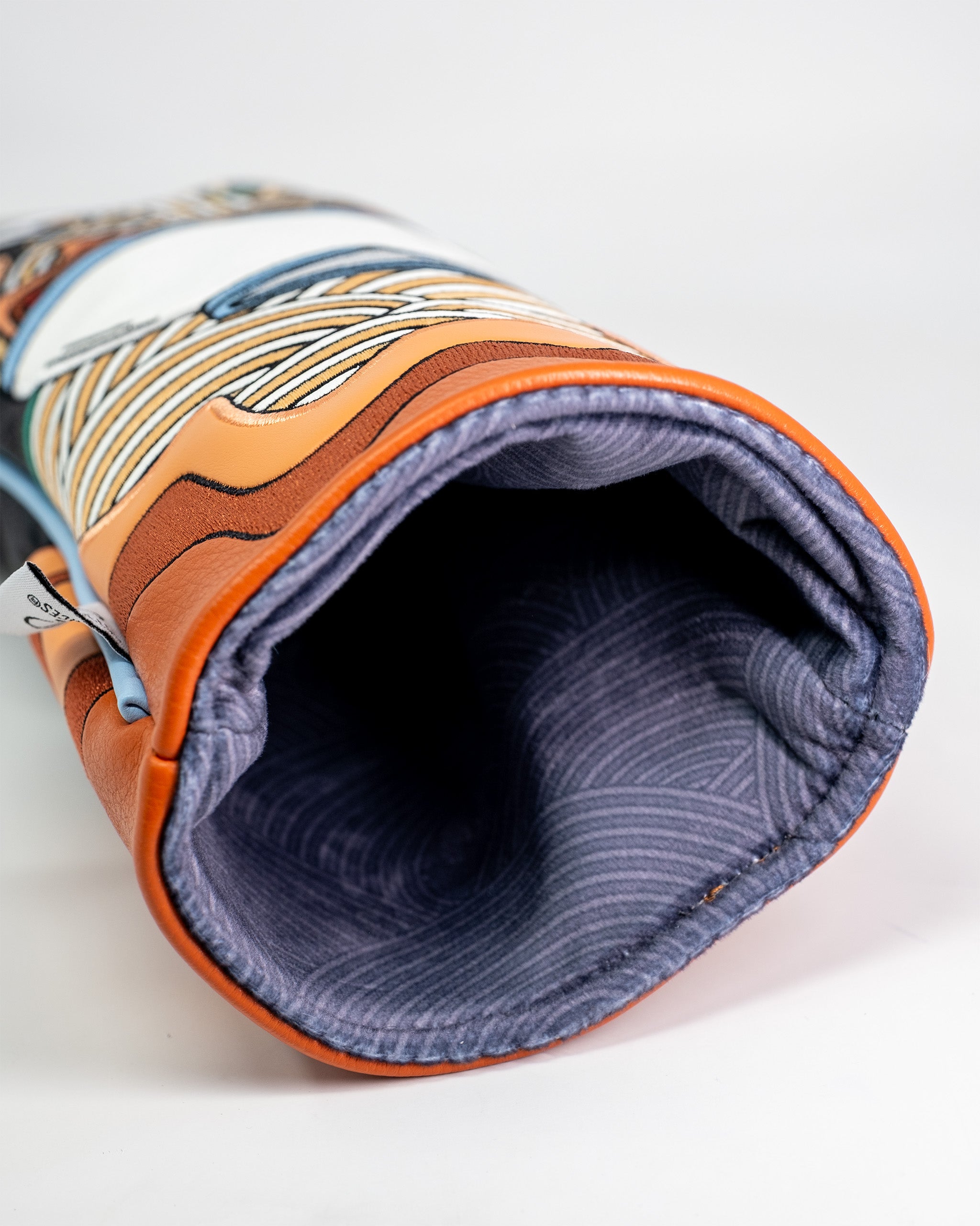 Ramen driver cover with colorful graphic design, orange trim, and a soft, striped interior lining.