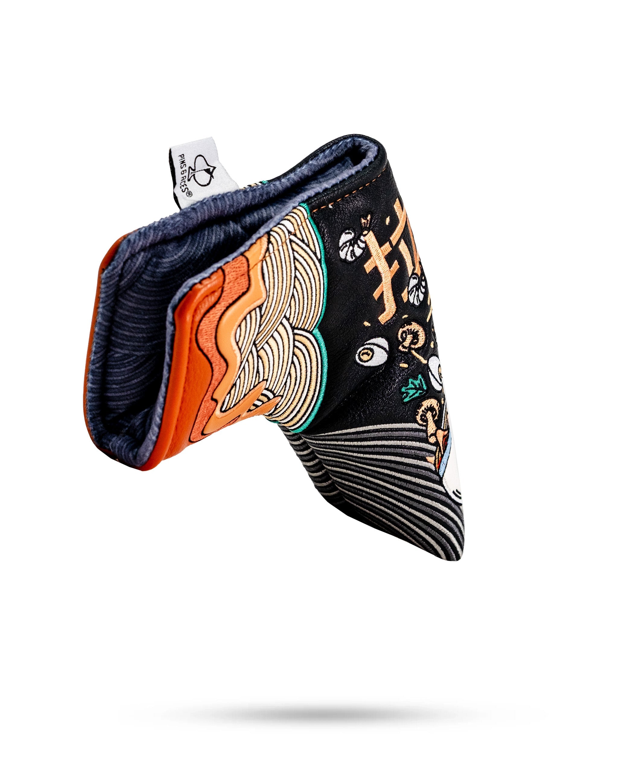 Colorful ramen bowl-themed blade putter cover with embroidered noodles and toppings, designed to protect golf clubs.