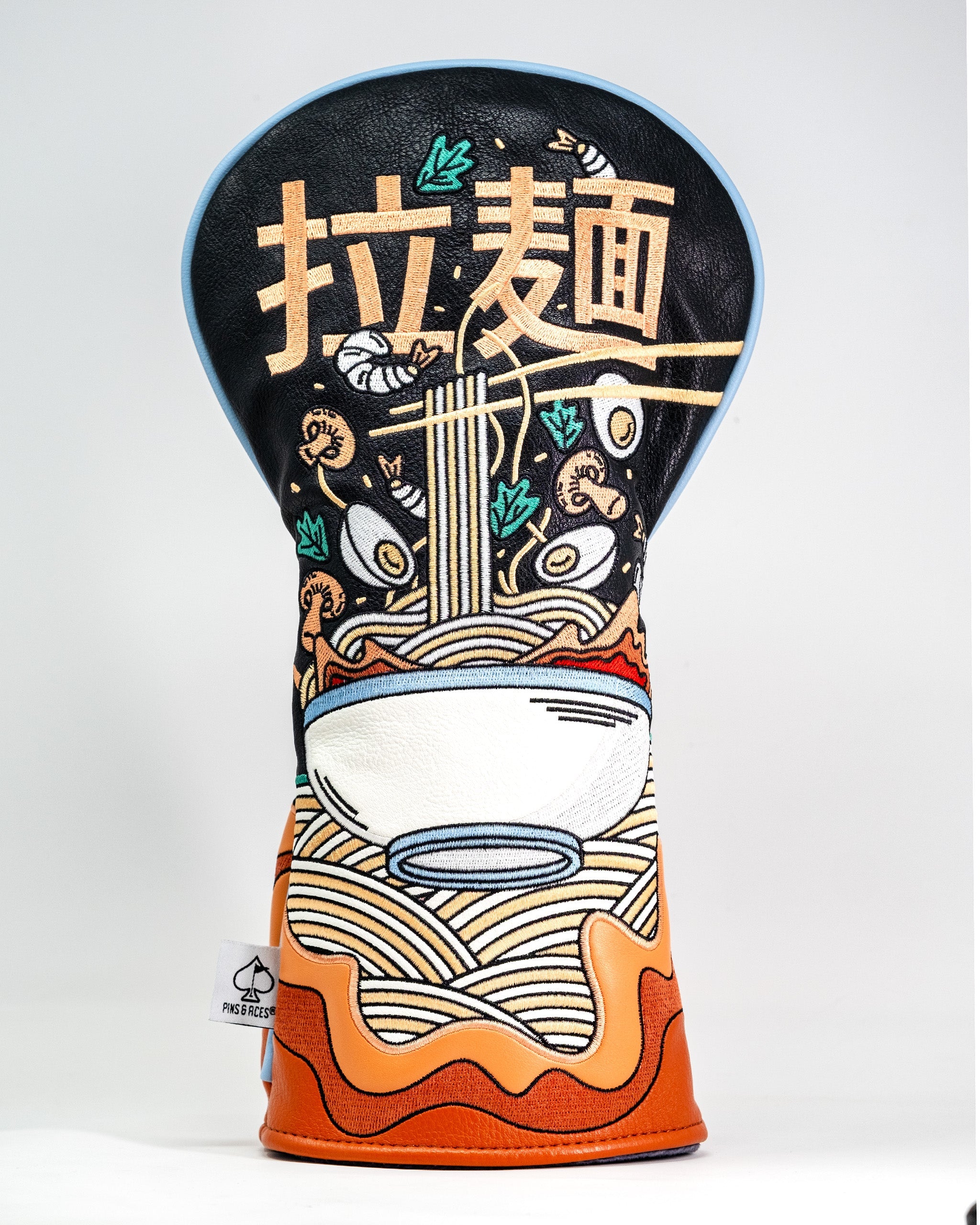 Embroidered golf driver cover featuring a ramen bowl design with noodles, eggs, vegetables, and chopsticks on a black background.