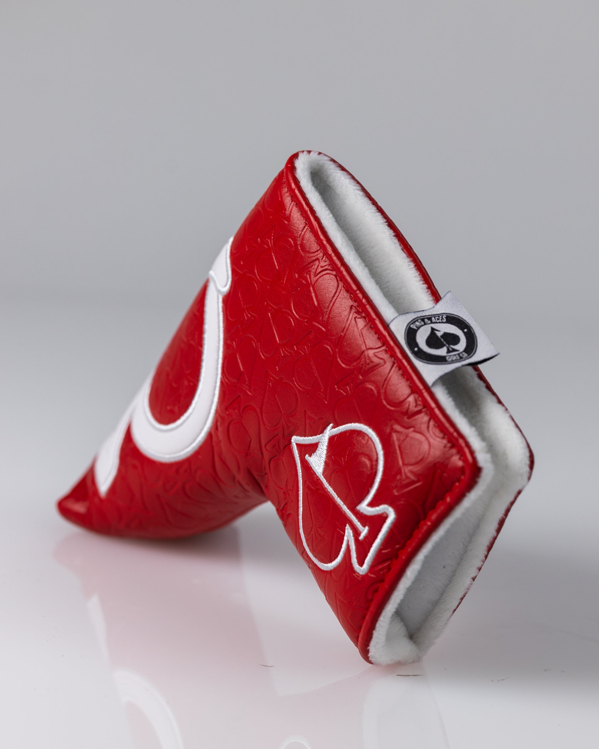 Red golf headcover with white embroidery, embossed pattern, and soft white lining for bold, standout style.