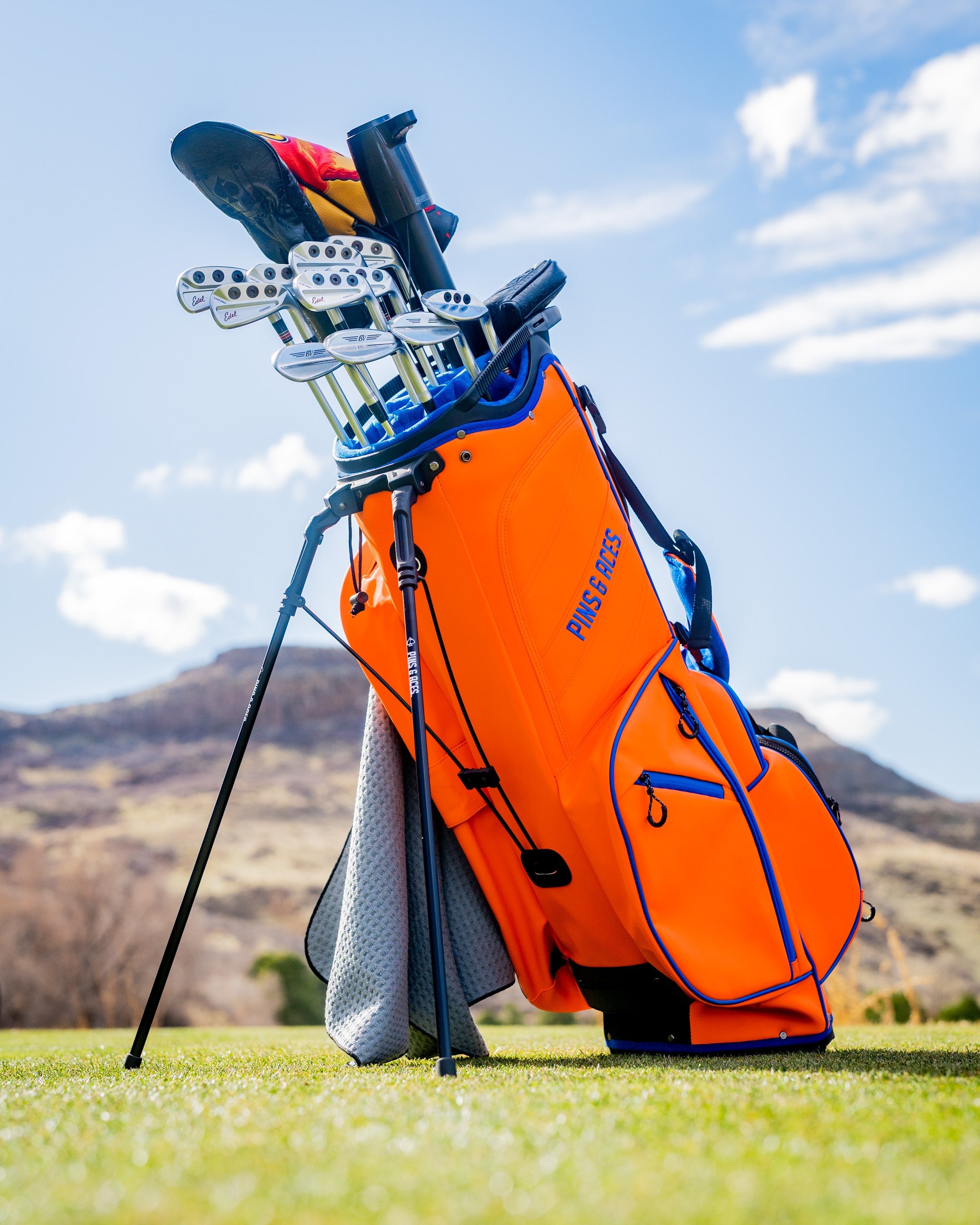 Player Preferred™ Golf Bag in vibrant orange with sleek design and multiple pockets for clubs and accessories.