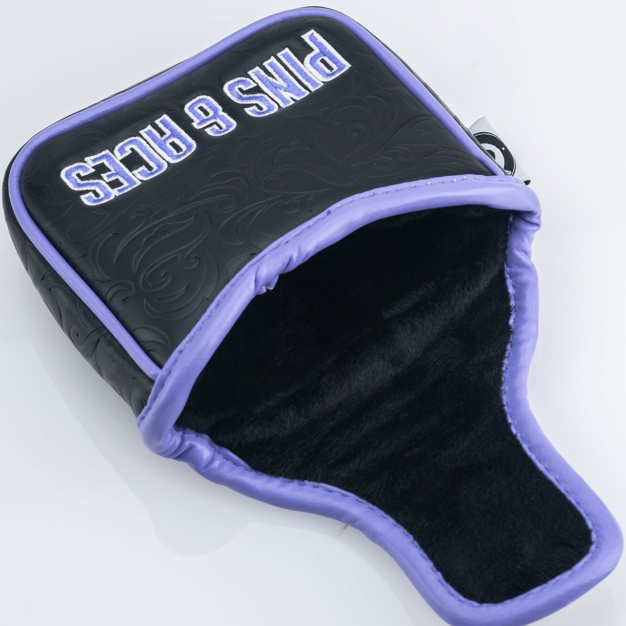 Black and purple Ace of Spades mallet putter cover with ornate embossing and soft black lining.