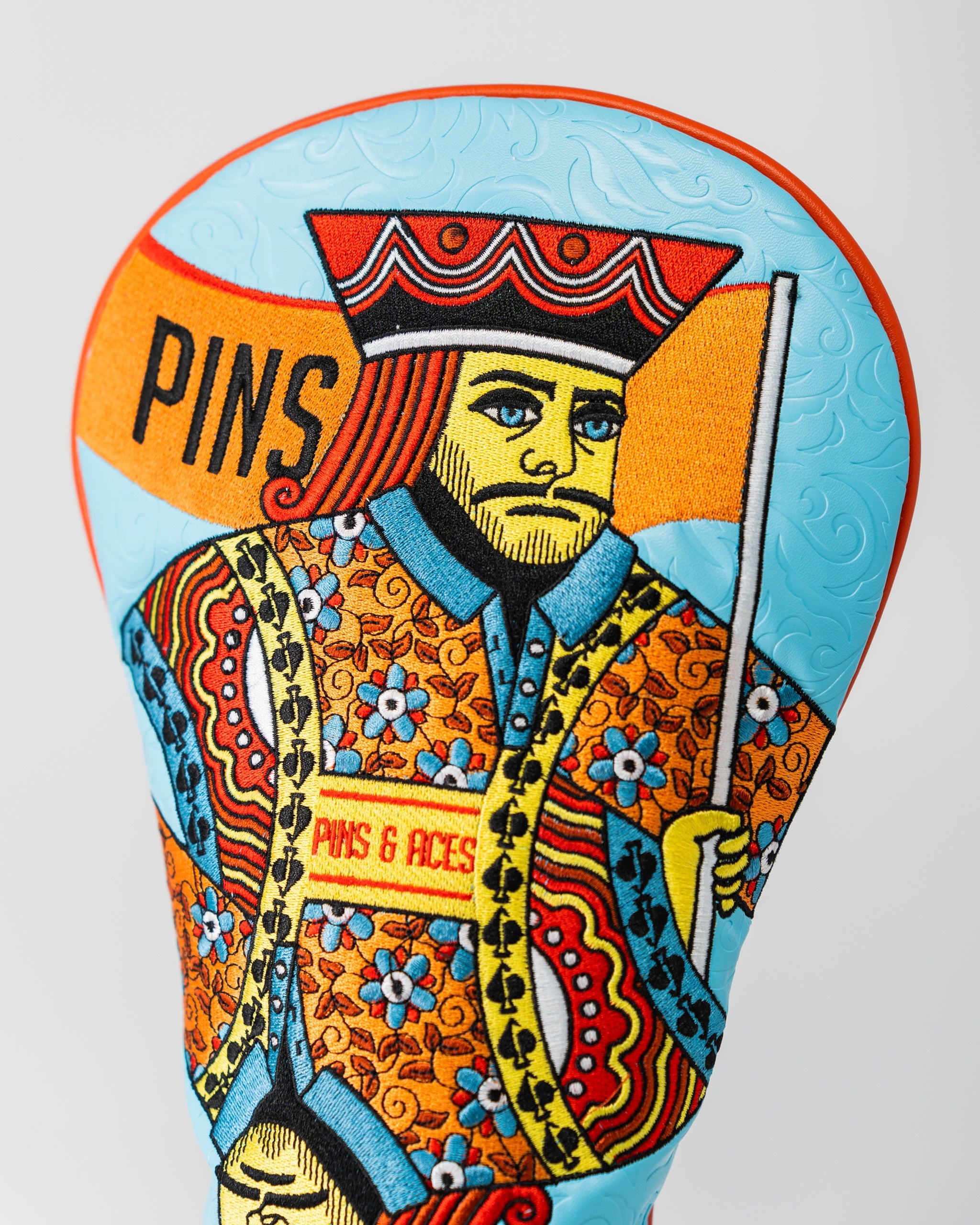 Bright orange King of Spades driver cover featuring a bold spade symbol, designed for golf clubs.