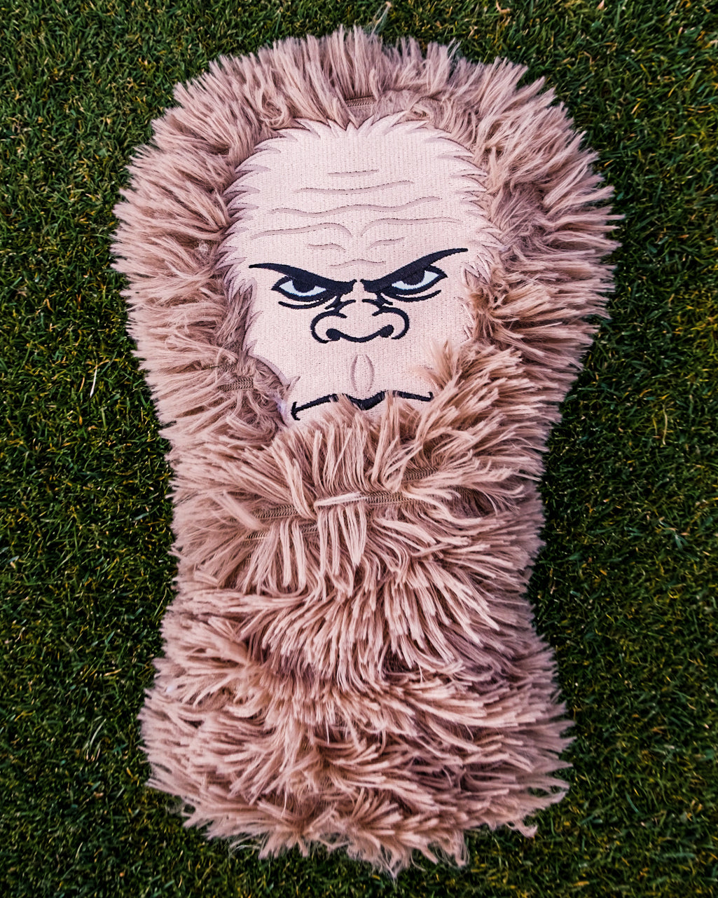 Sasquatch driver cover featuring a playful Sasquatch design on a green background, perfect for golf enthusiasts.