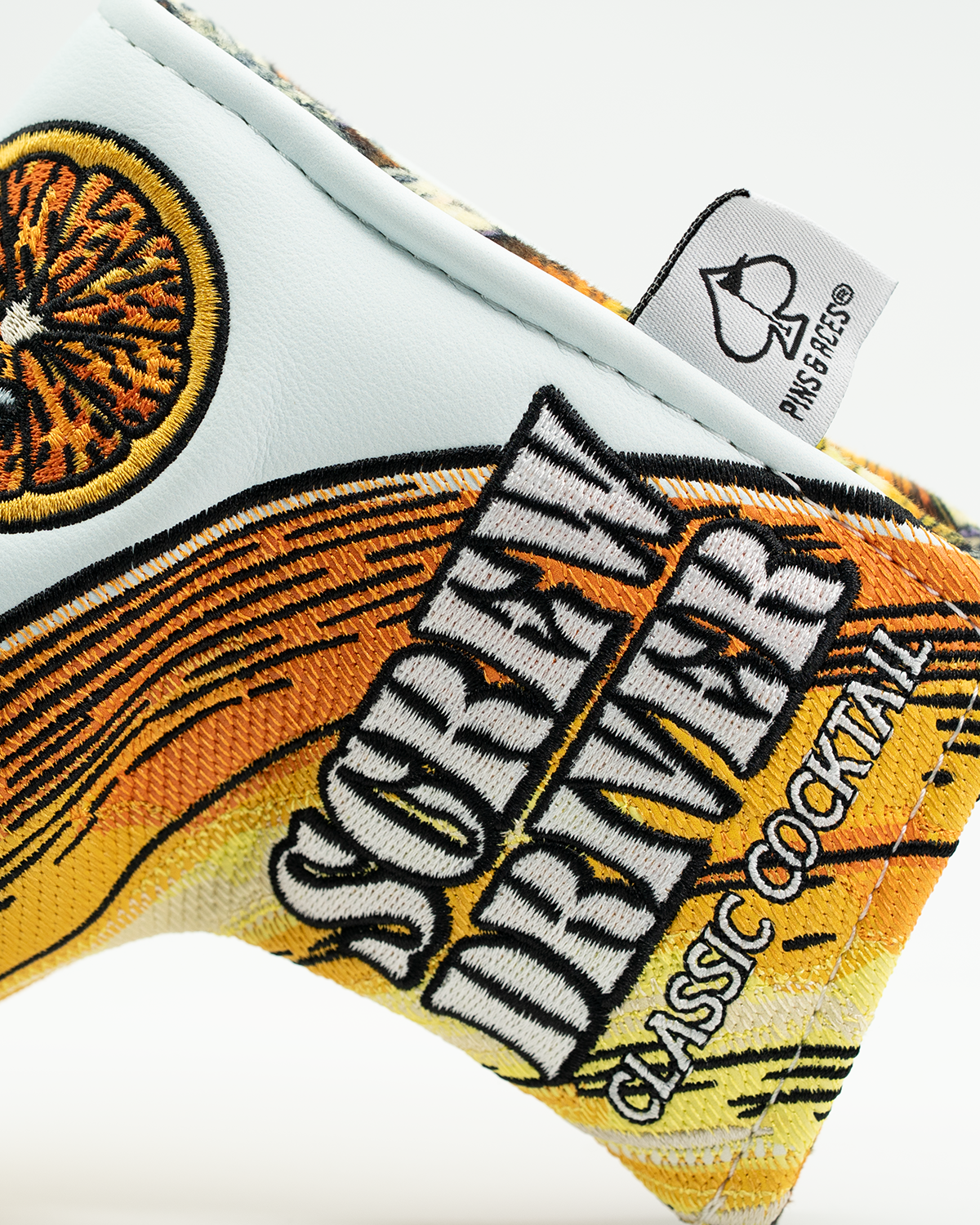Colorful Blade Putter Cover featuring a vibrant orange design and "Screwdriver Classic Cocktail" text for golfers.