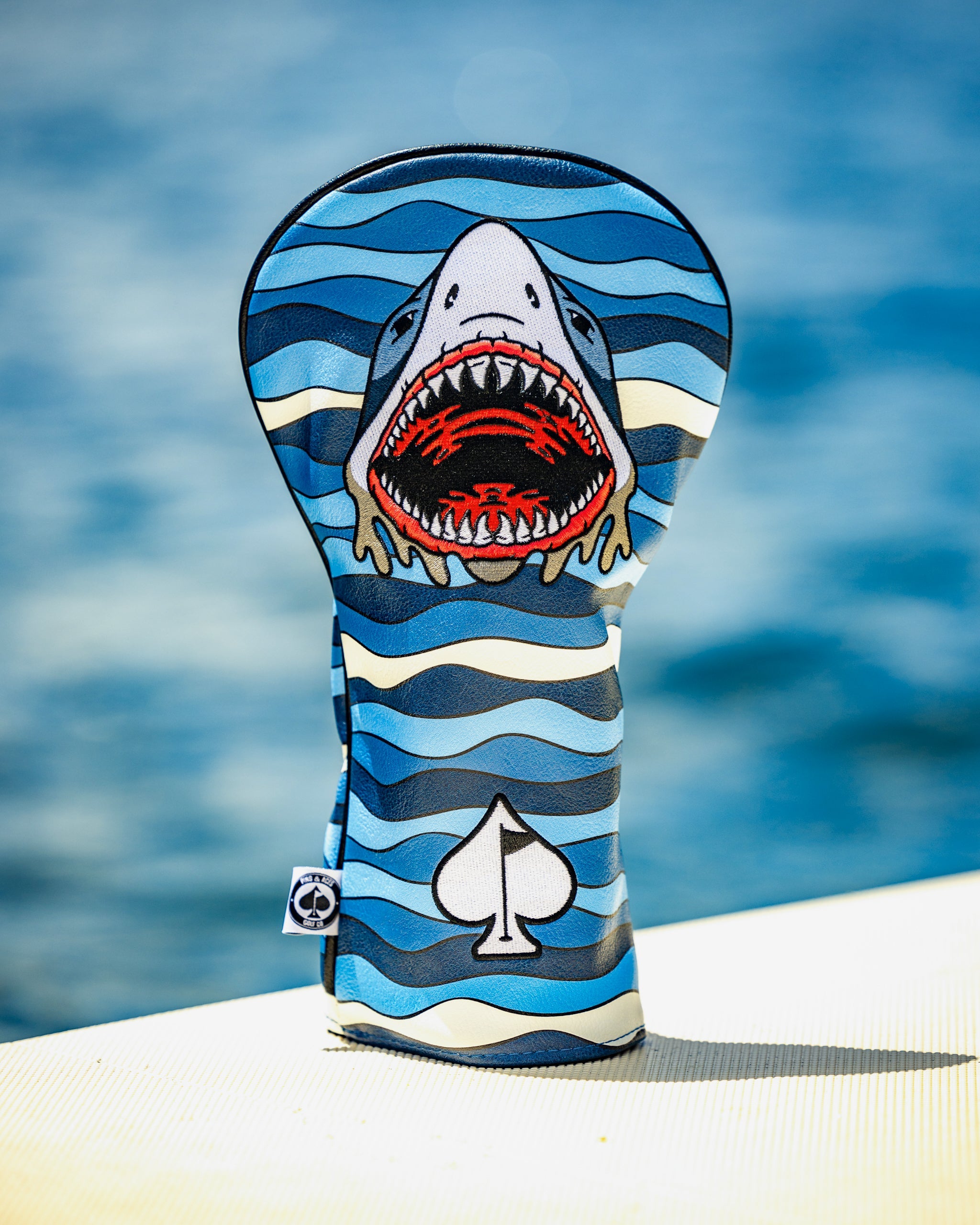Shark Attack driver cover featuring a vibrant shark design on a black background, designed to protect golf clubs.
