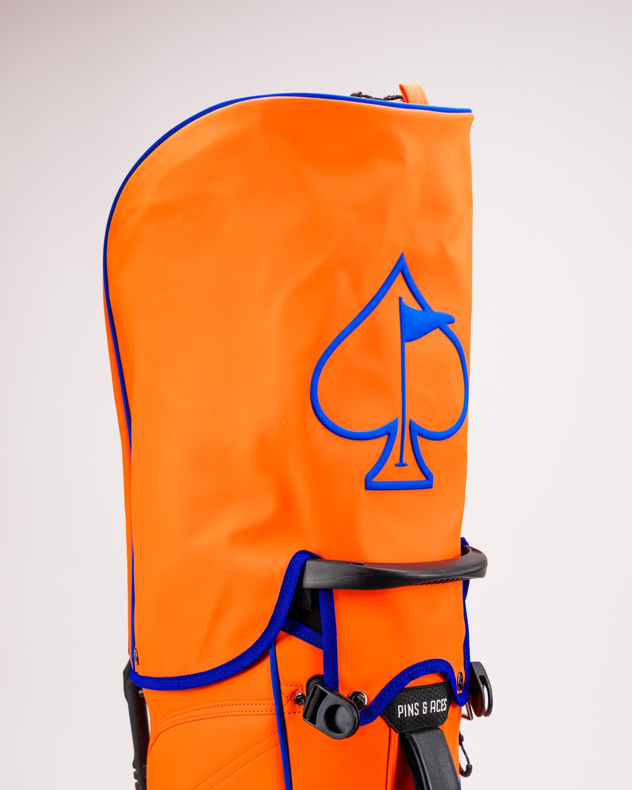 Player Preferred™ Golf Bag in vibrant orange with multiple pockets and a padded strap for easy carrying.