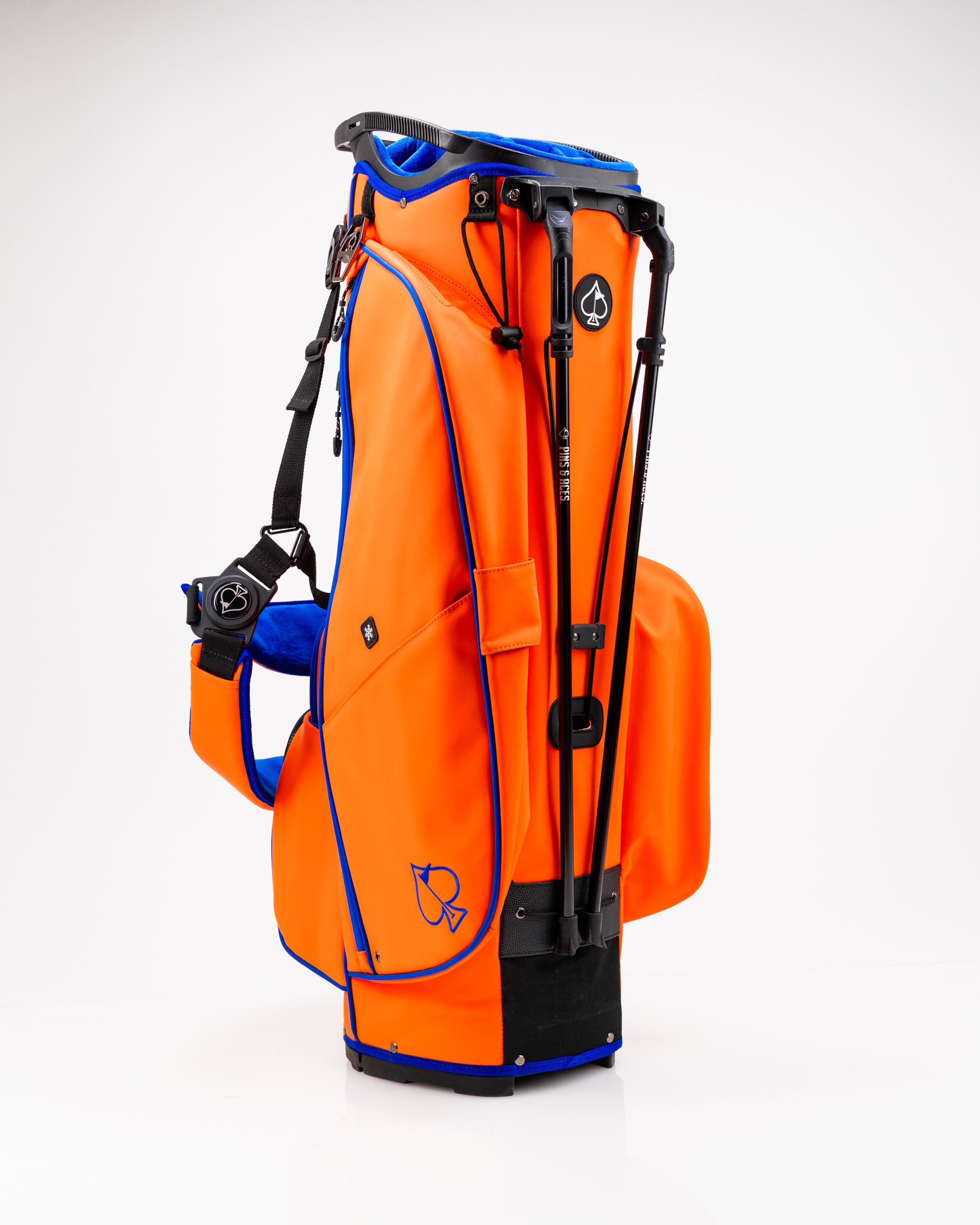 Player Preferred™ Golf Bag in vibrant orange with black accents, featuring multiple pockets and a padded strap for comfort.