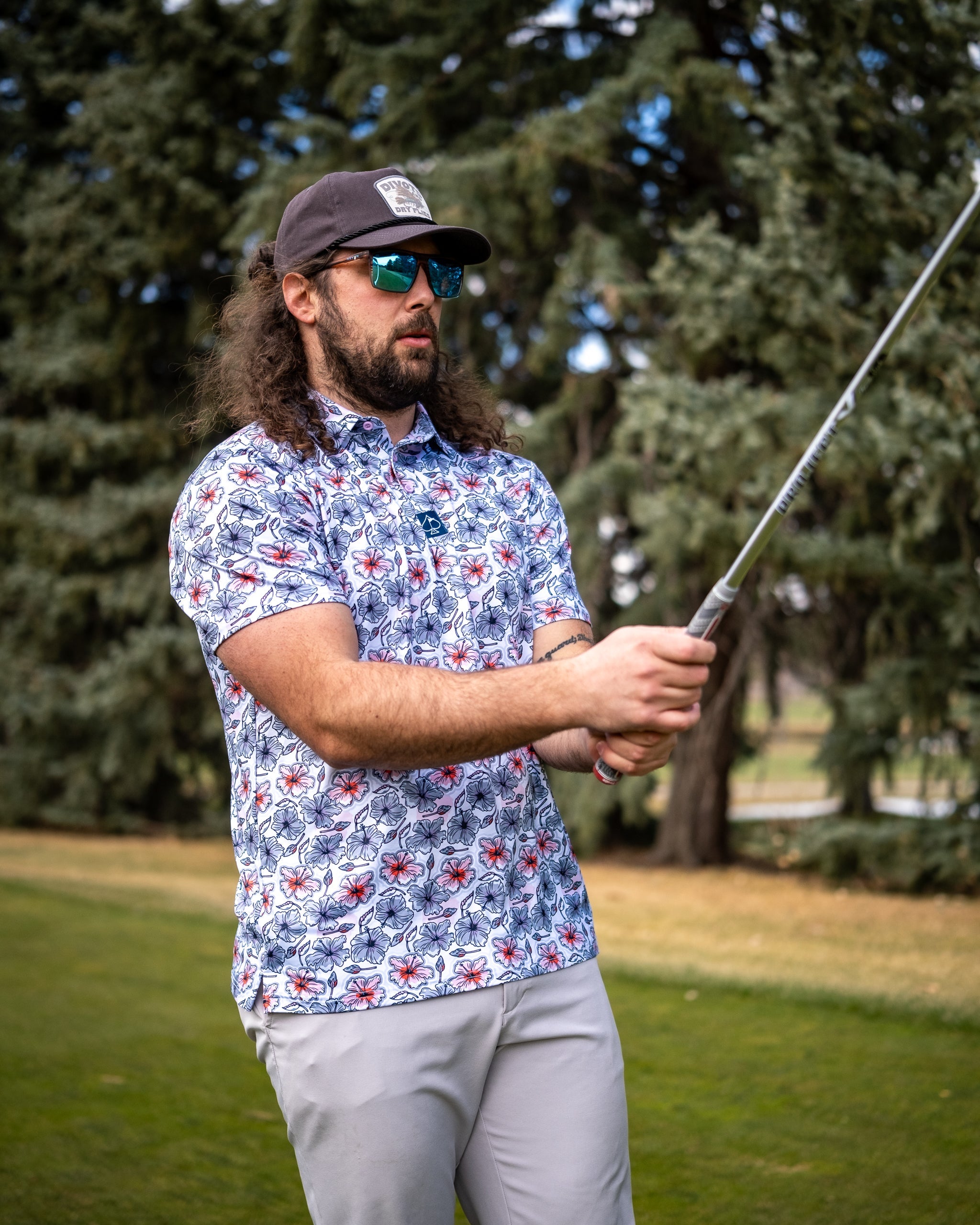 Hibiscus Harmony floral arrangement featuring vibrant hibiscus flowers in a stylish vase against a light background.