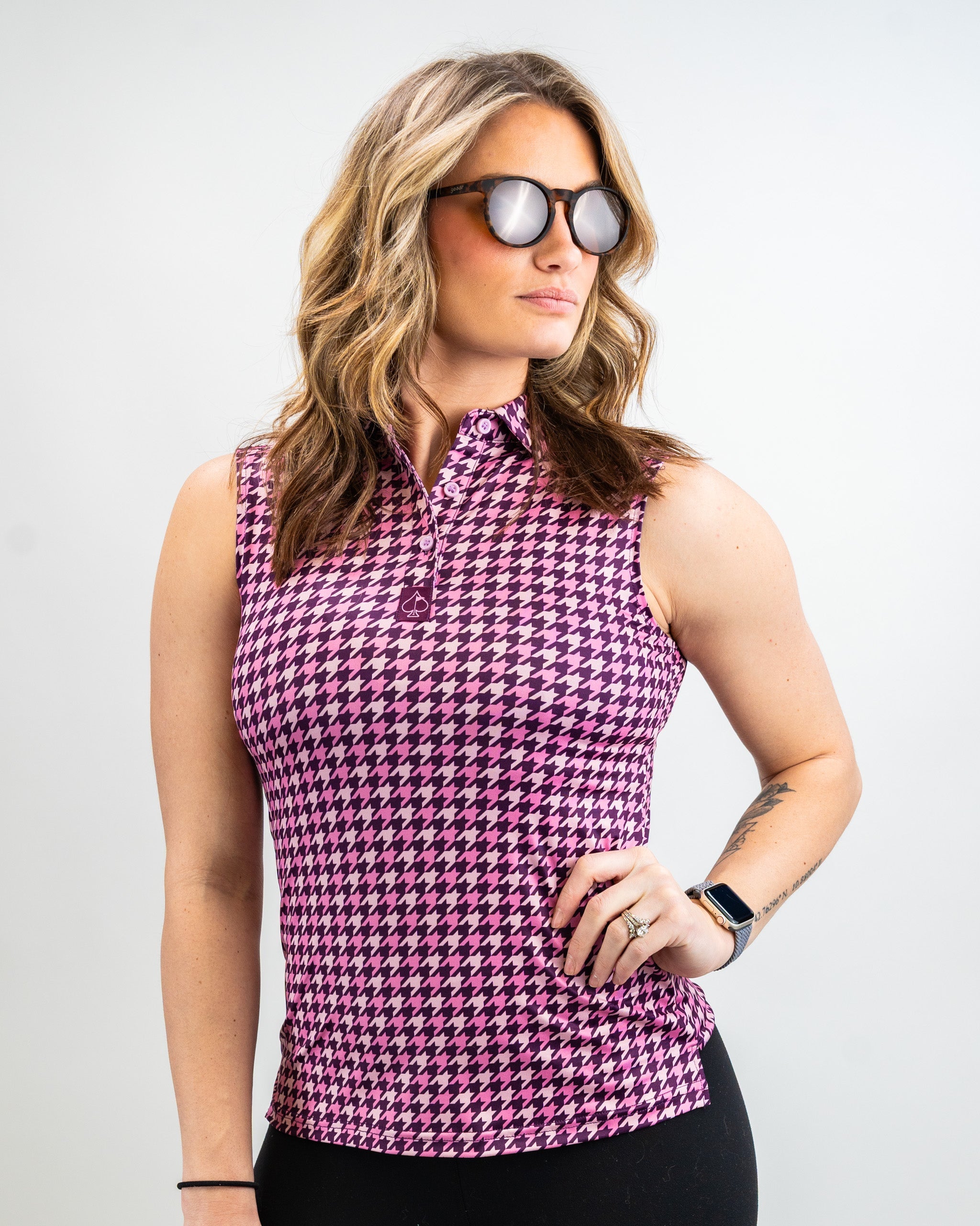 Women's houndstooth sweater in raspberry color, featuring a classic pattern and round neckline.