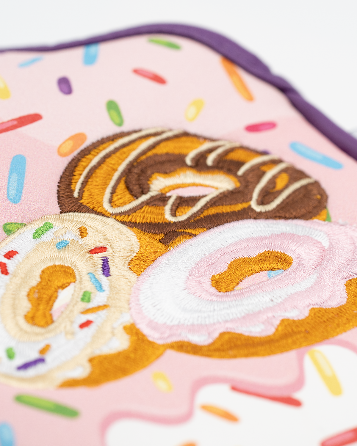 Colorful mallet putter cover featuring embroidered donuts on a pink background with sprinkles. Ideal for unique golf style.