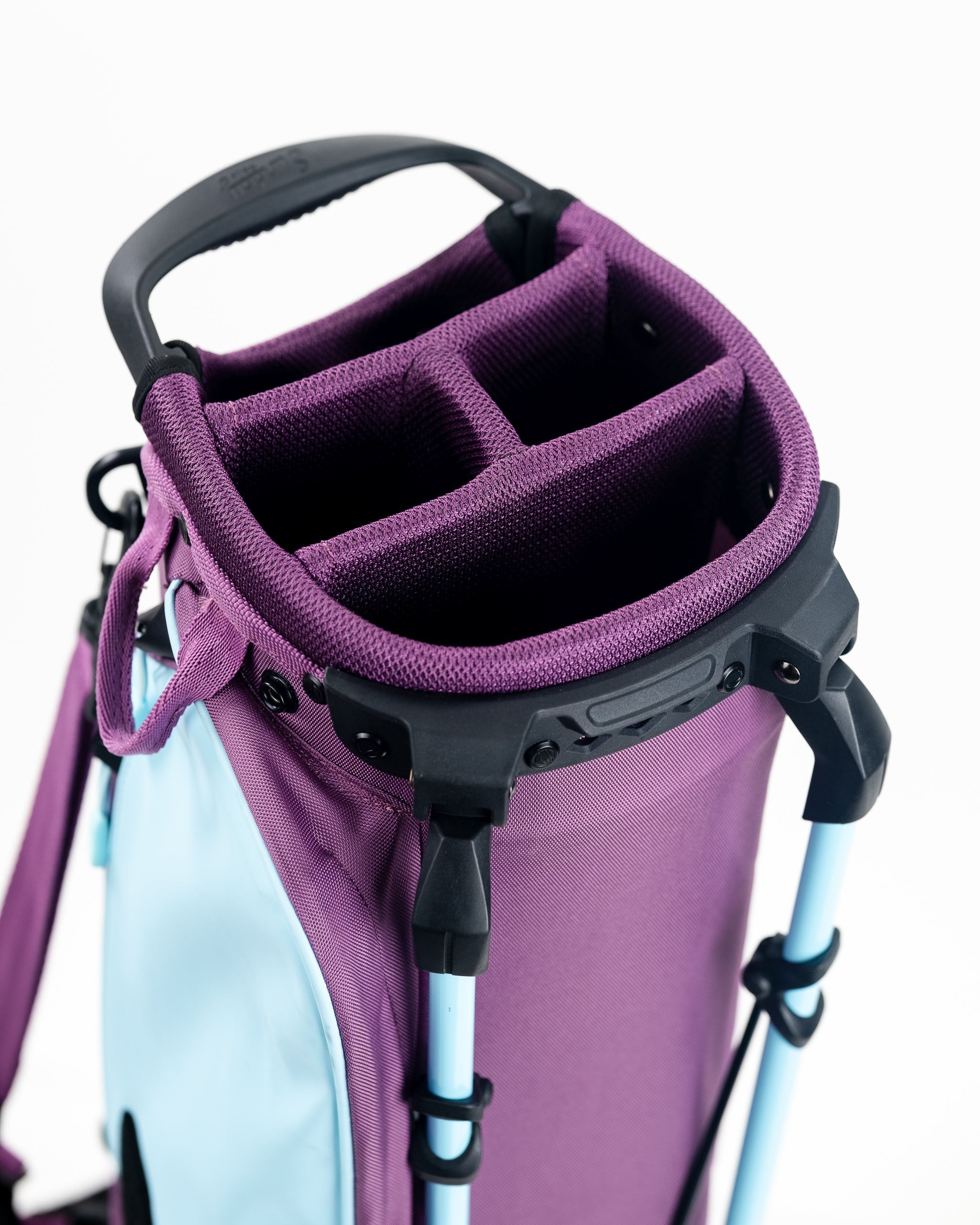 Close-up of a purple golf cart bag with three divided compartments, black handle, and light blue accents, designed for bol...