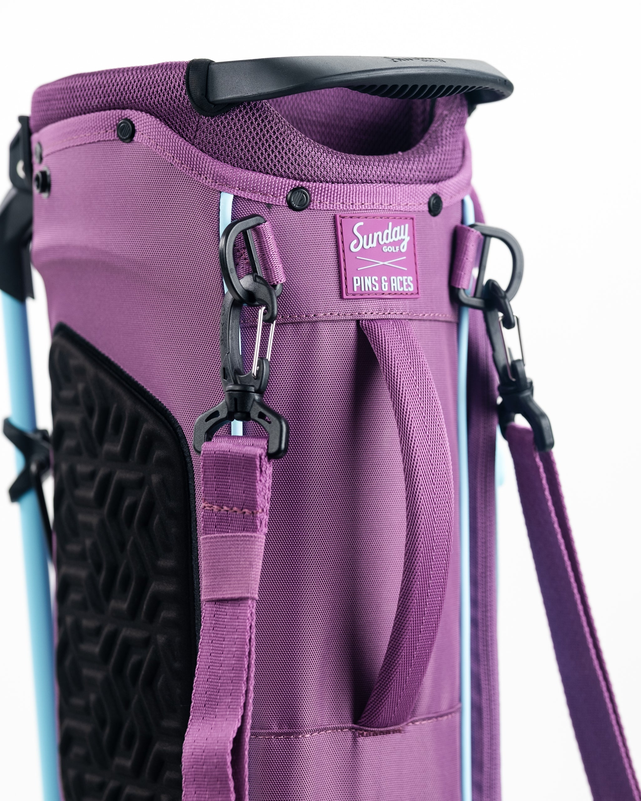 Bright purple golf bag with black accents, logo patch, and adjustable strap, designed for bold, standout golf style.