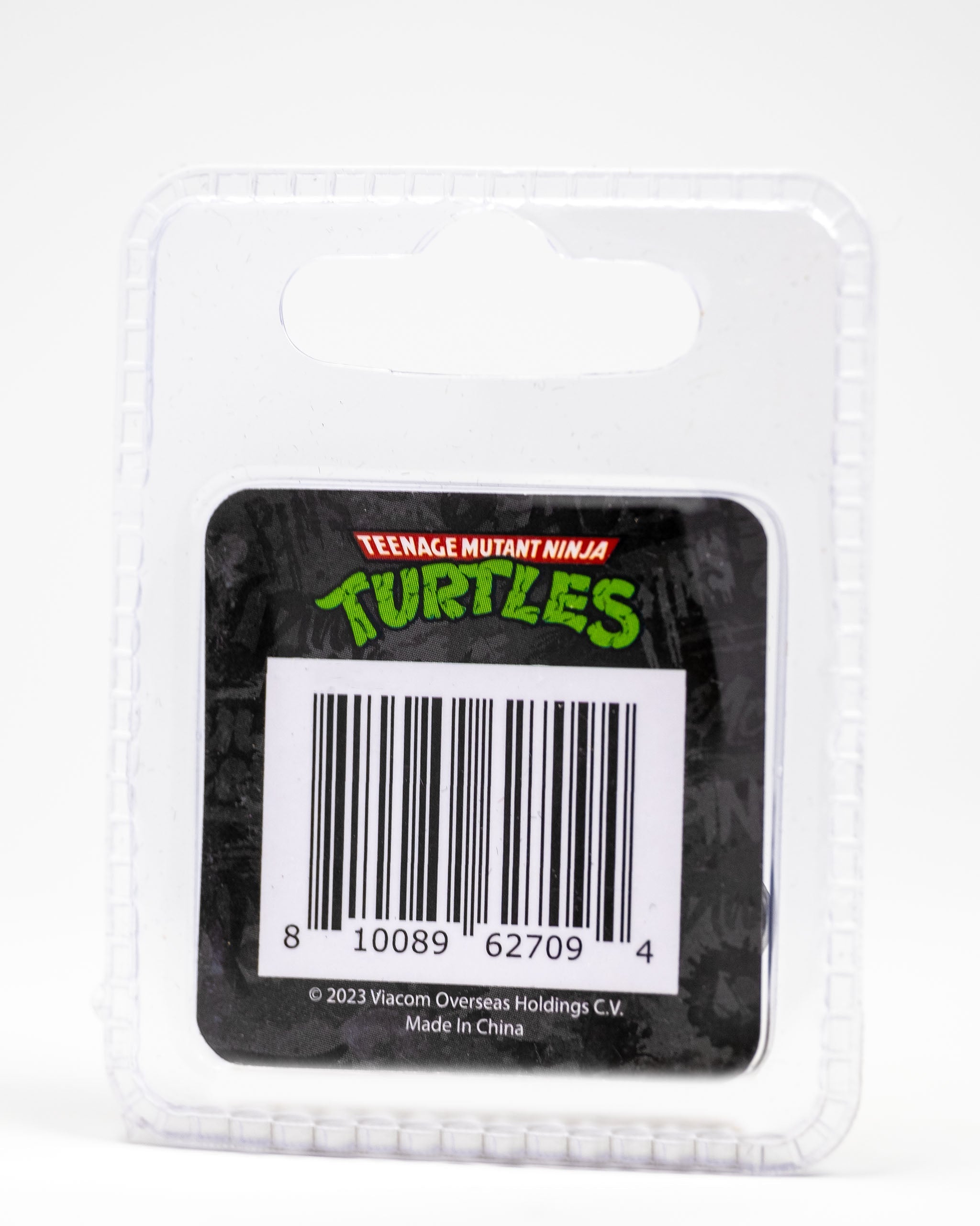 TMNT Shell Shock Ball Marker featuring colorful Teenage Mutant Ninja Turtles graphics on a round, metal design.