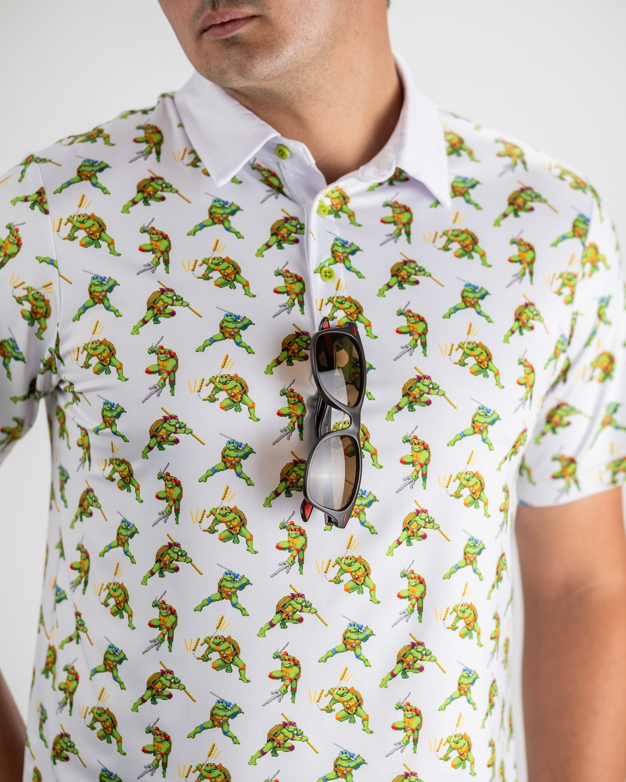 TMNT Cowabunga Classic 8-Bit graphic design featuring Teenage Mutant Ninja Turtles in retro style on a shirt.