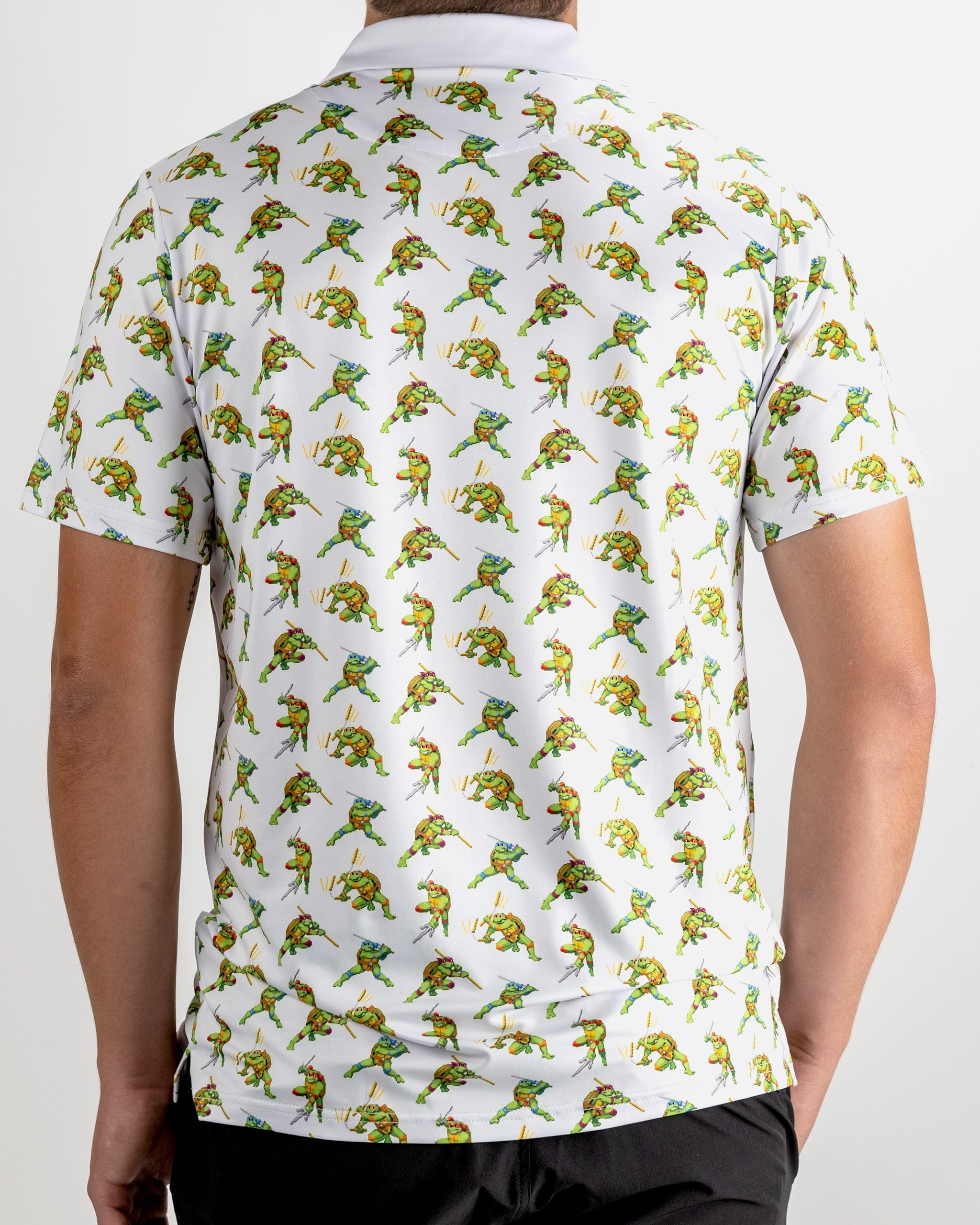 TMNT Cowabunga Classic 8-Bit graphic on a vibrant green polo shirt featuring retro Teenage Mutant Ninja Turtles design.