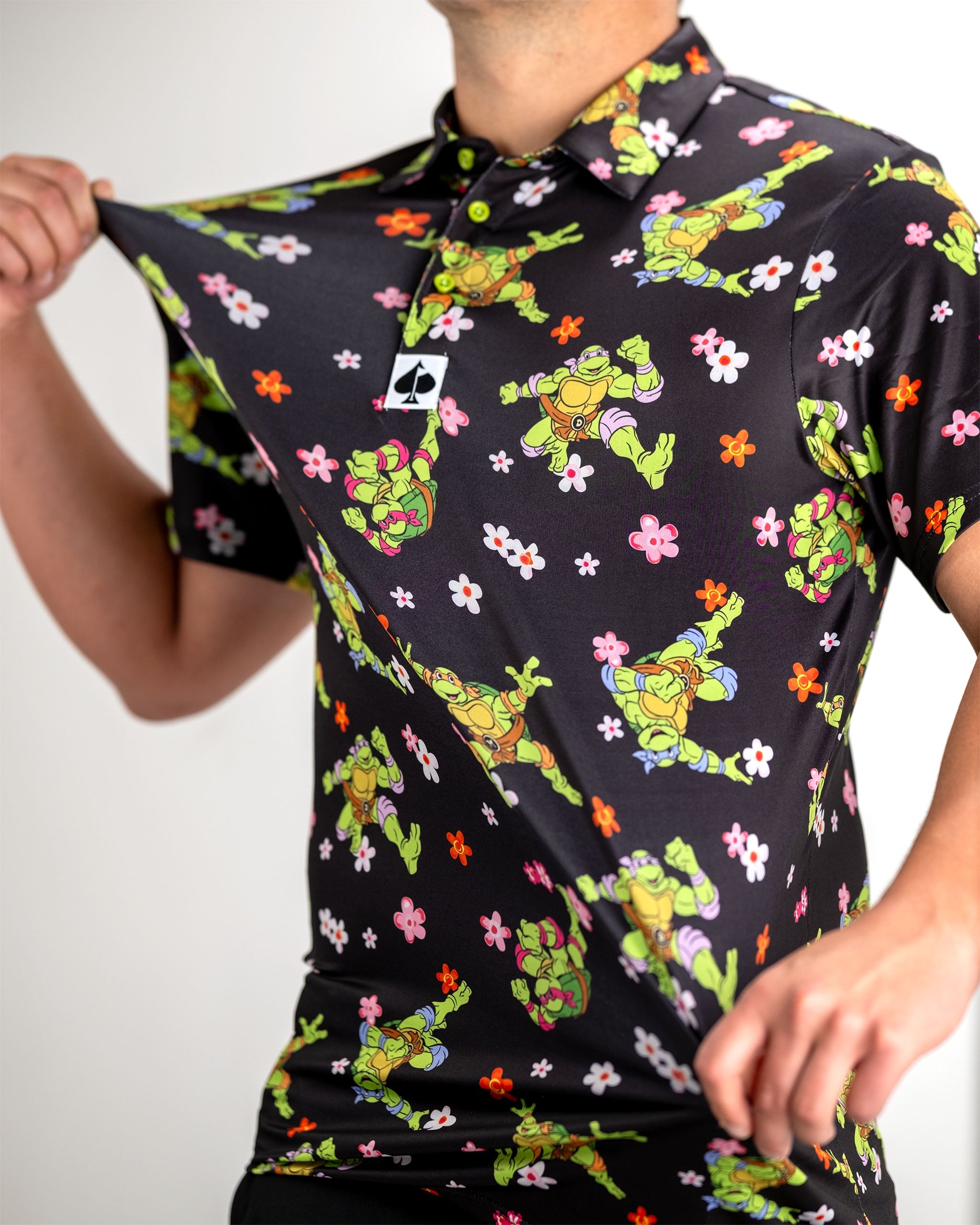 TMNT Turtle Flower Power graphic polo featuring vibrant colors and iconic Teenage Mutant Ninja Turtles design.