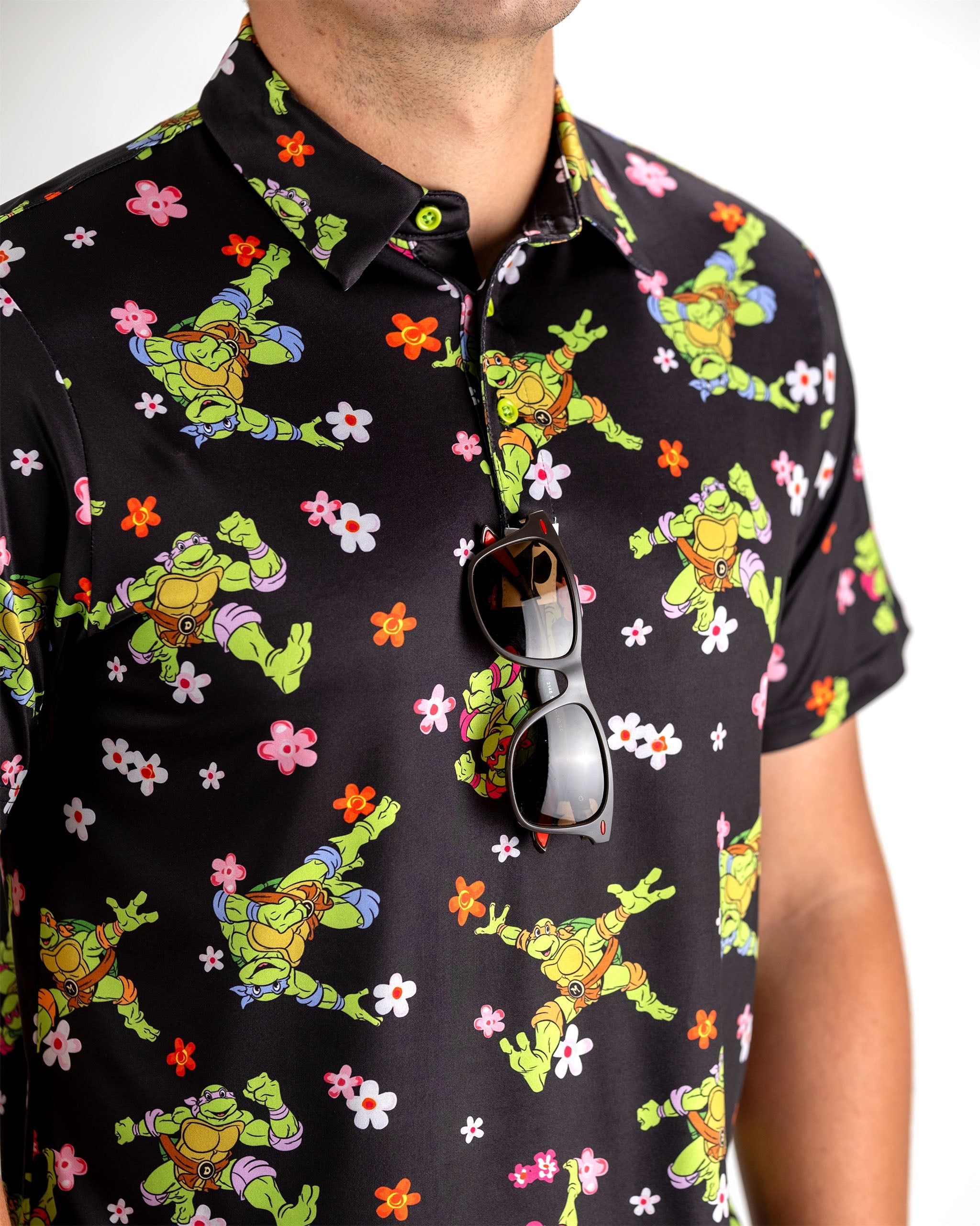TMNT Turtle Flower Power graphic tee featuring vibrant colors and iconic Teenage Mutant Ninja Turtles characters surrounded by floral designs.
