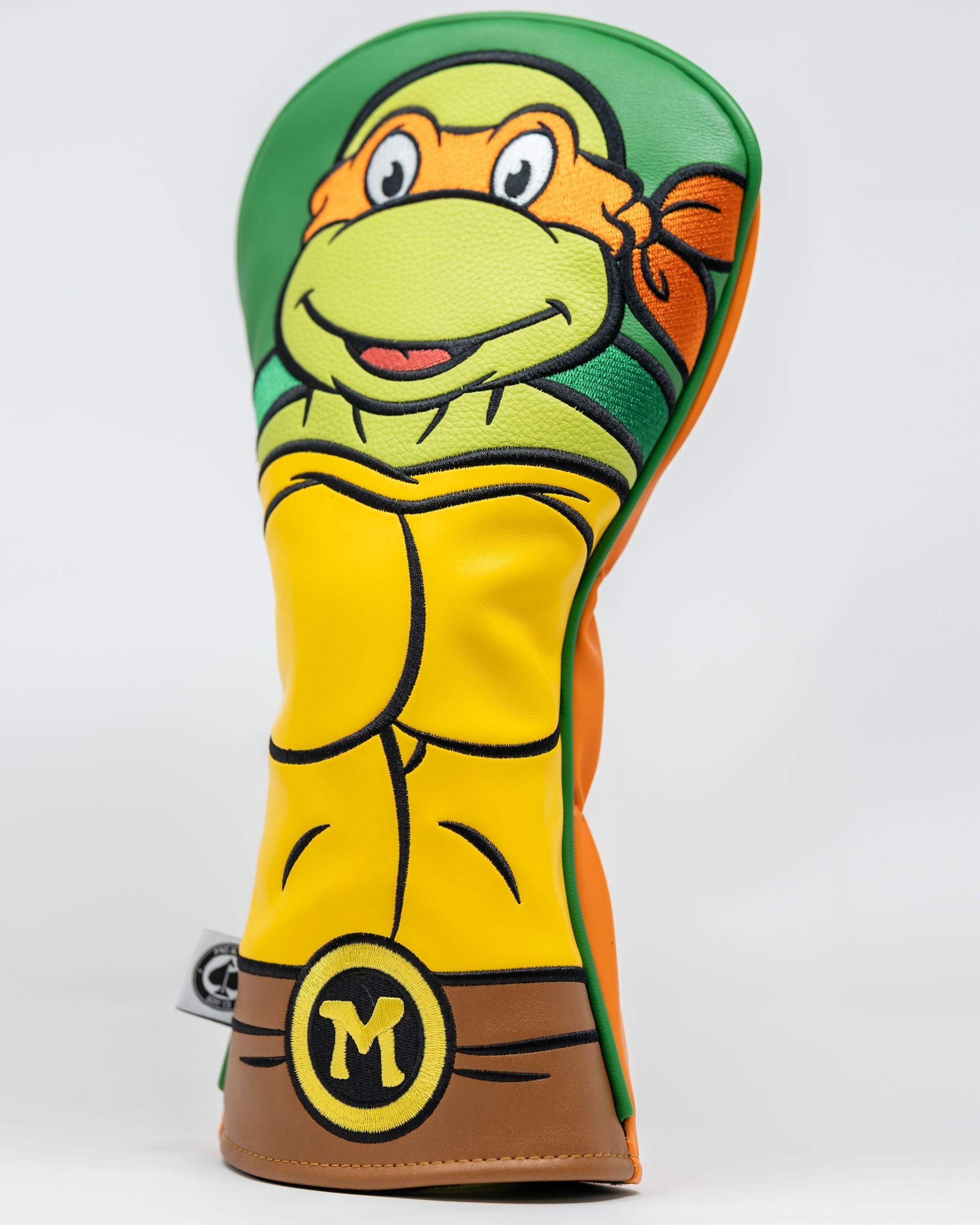 TMNT Michelangelo headcover featuring vibrant orange colors and character design, ideal for golf clubs.