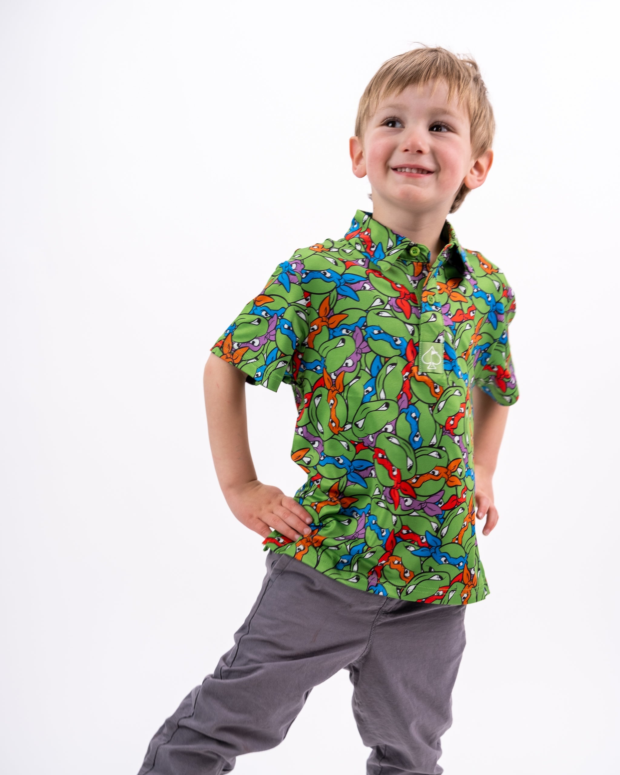 Youth TMNT Mean Green t-shirt featuring the Teenage Mutant Ninja Turtles graphic design, modeled by a child.