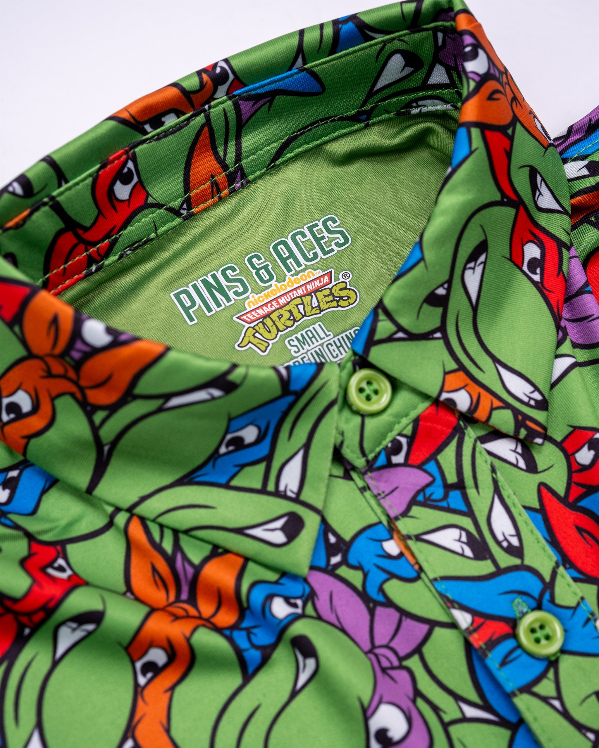 TMNT Youth Mean Green t-shirt featuring vibrant graphics of Teenage Mutant Ninja Turtles on a green background.