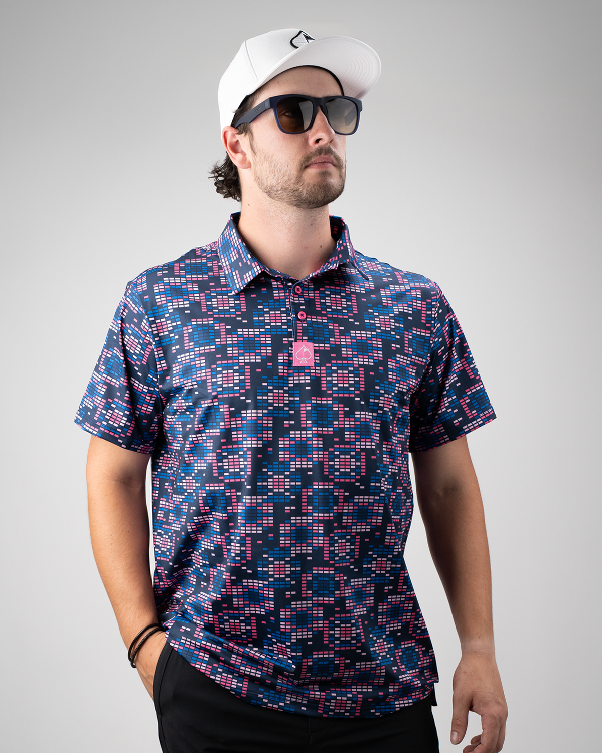 Men's Tetrafloral Dark golf polo featuring a bold geometric pattern in navy, pink, and white, perfect for stylish play on the course.