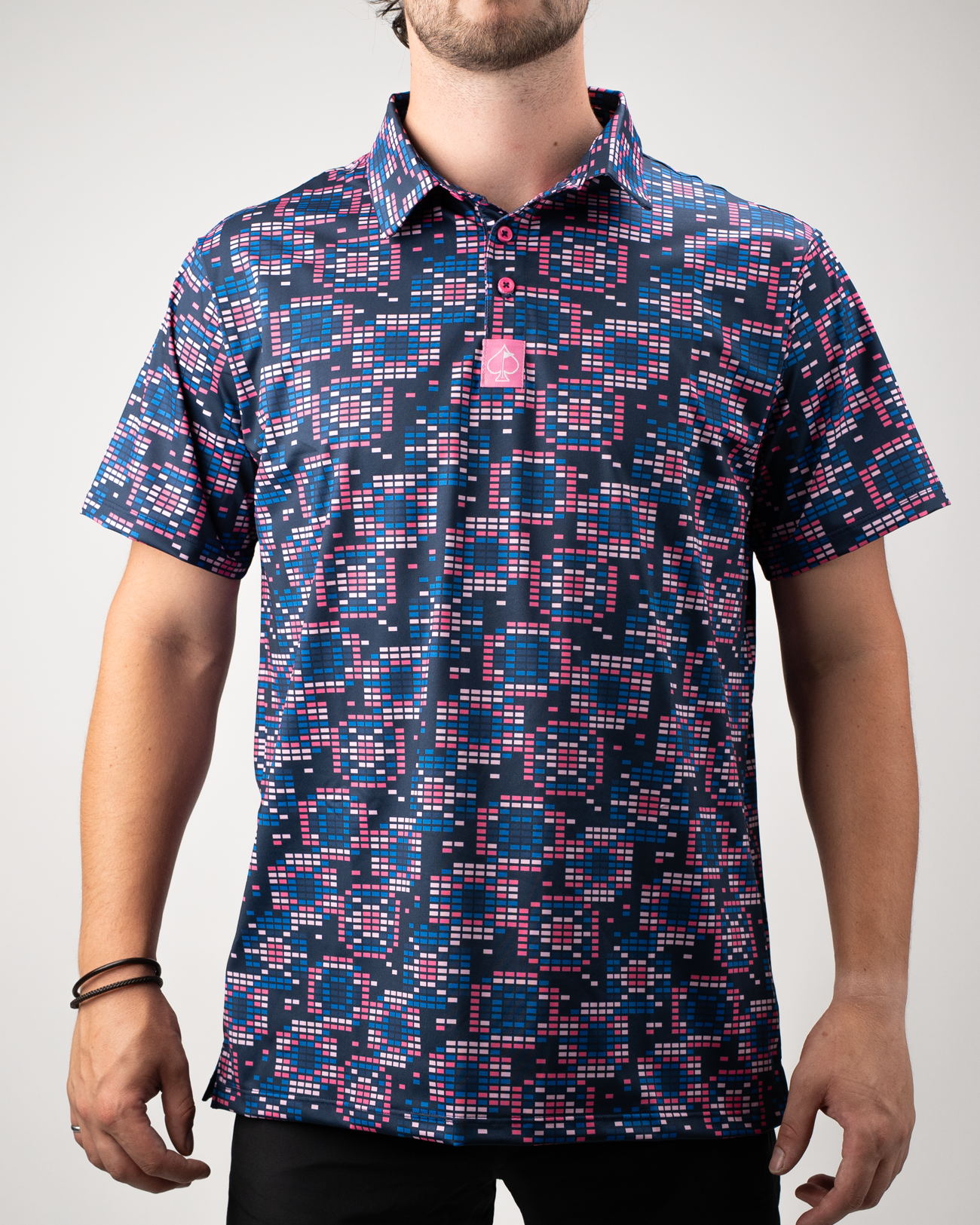 Men's Tetrafloral Dark golf shirt featuring a bold geometric pattern in navy, pink, and teal, perfect for stylish play on the course.