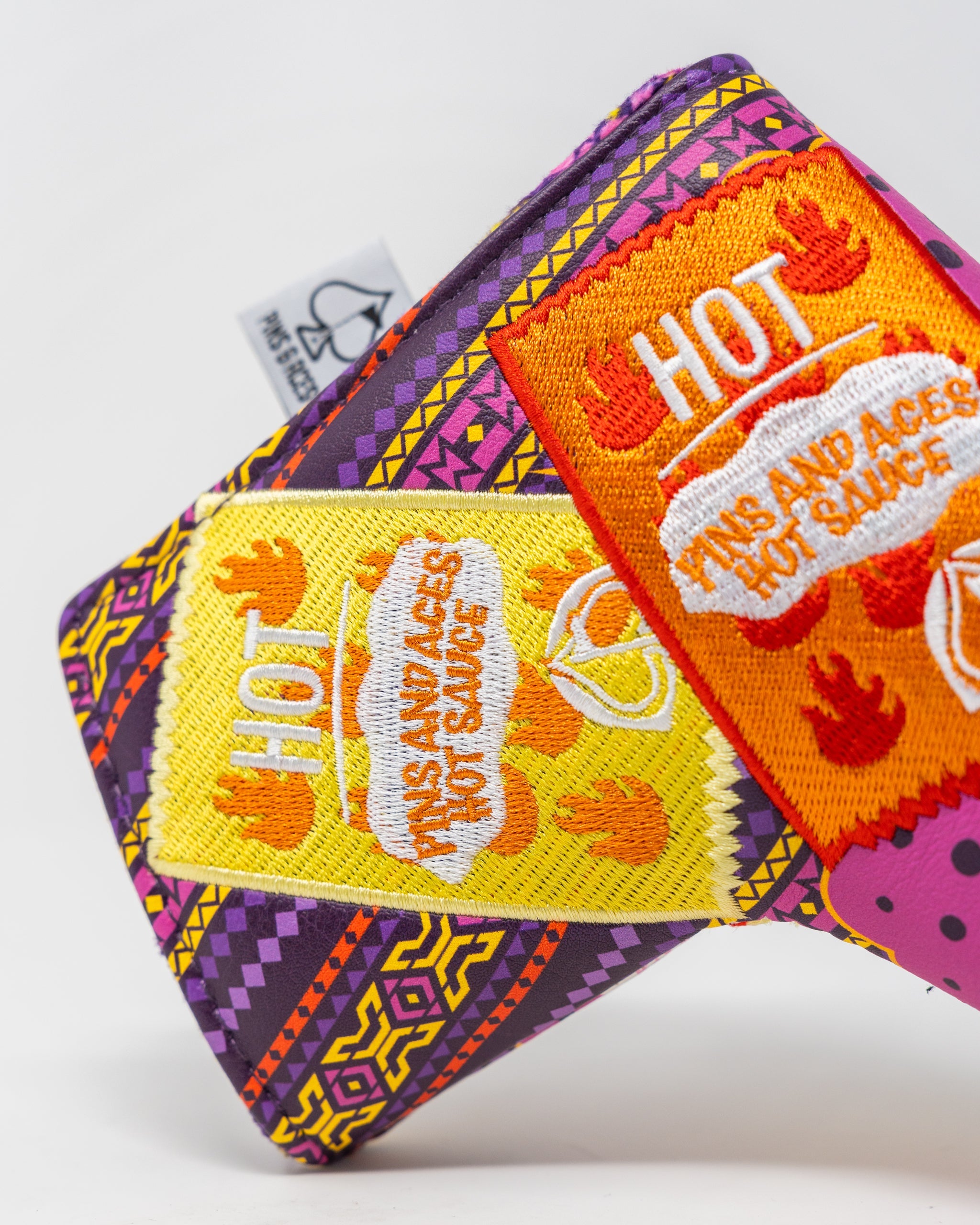 Alt text: "The Bogey Supreme blade putter cover in sleek black with vibrant green and white accents, featuring a stylish design for protecting golf putters."