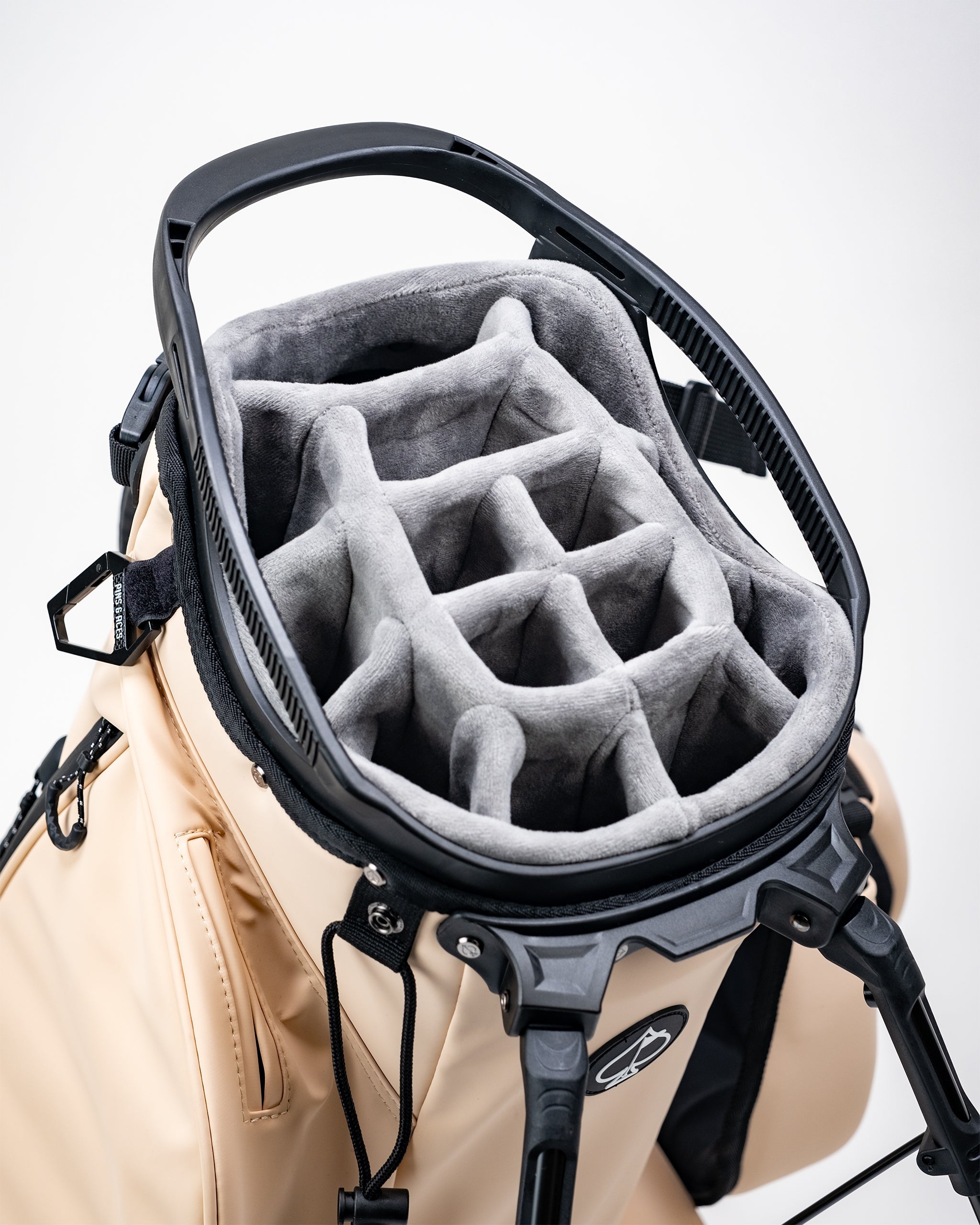 Golf cart with a beige bag and a gray, plush, ringed golf headcover inside, designed for bold, standout golf accessories.