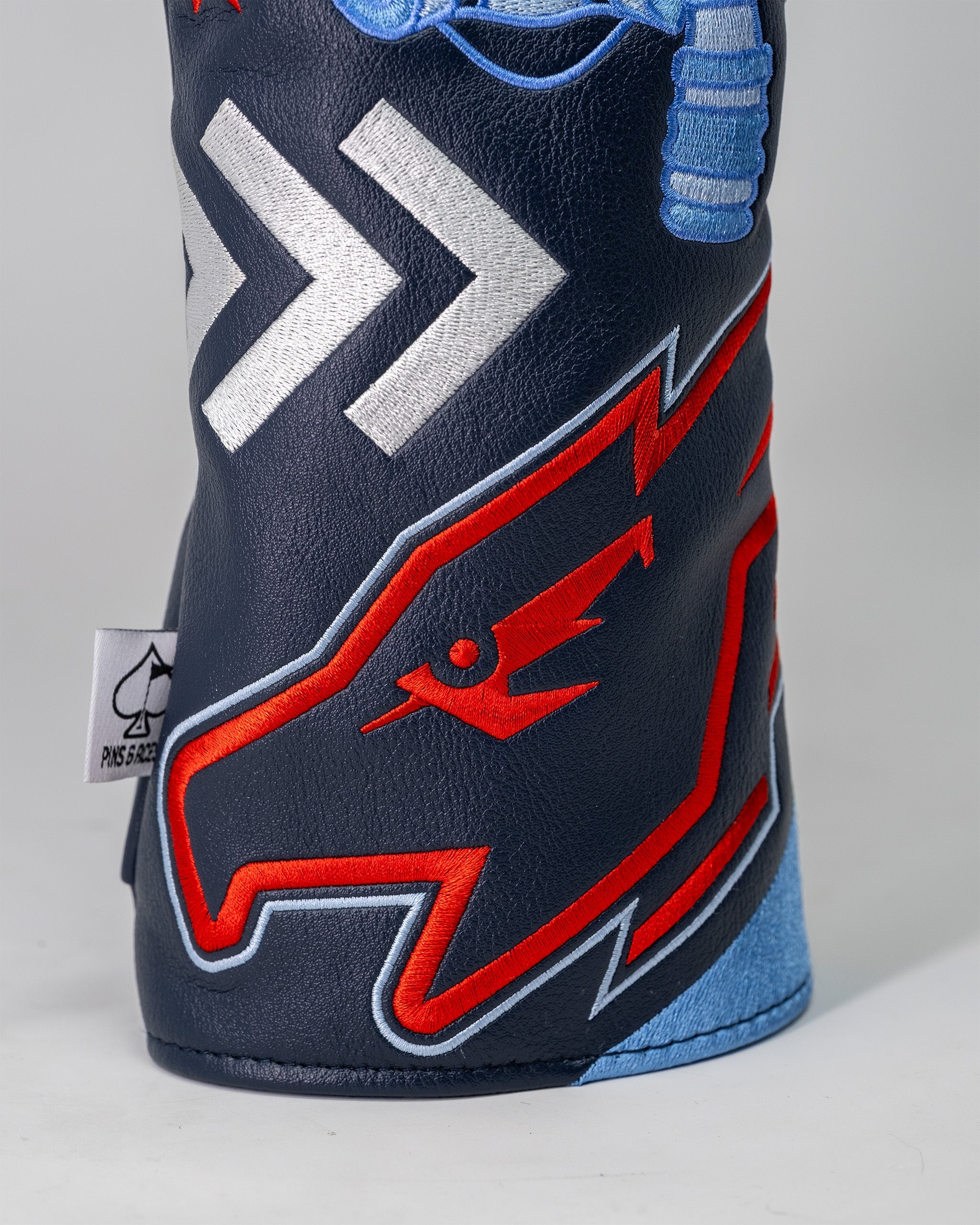 Golf driver headcover featuring a Top Gun Maverick design with embroidered red, white, and blue graphics on navy leather.