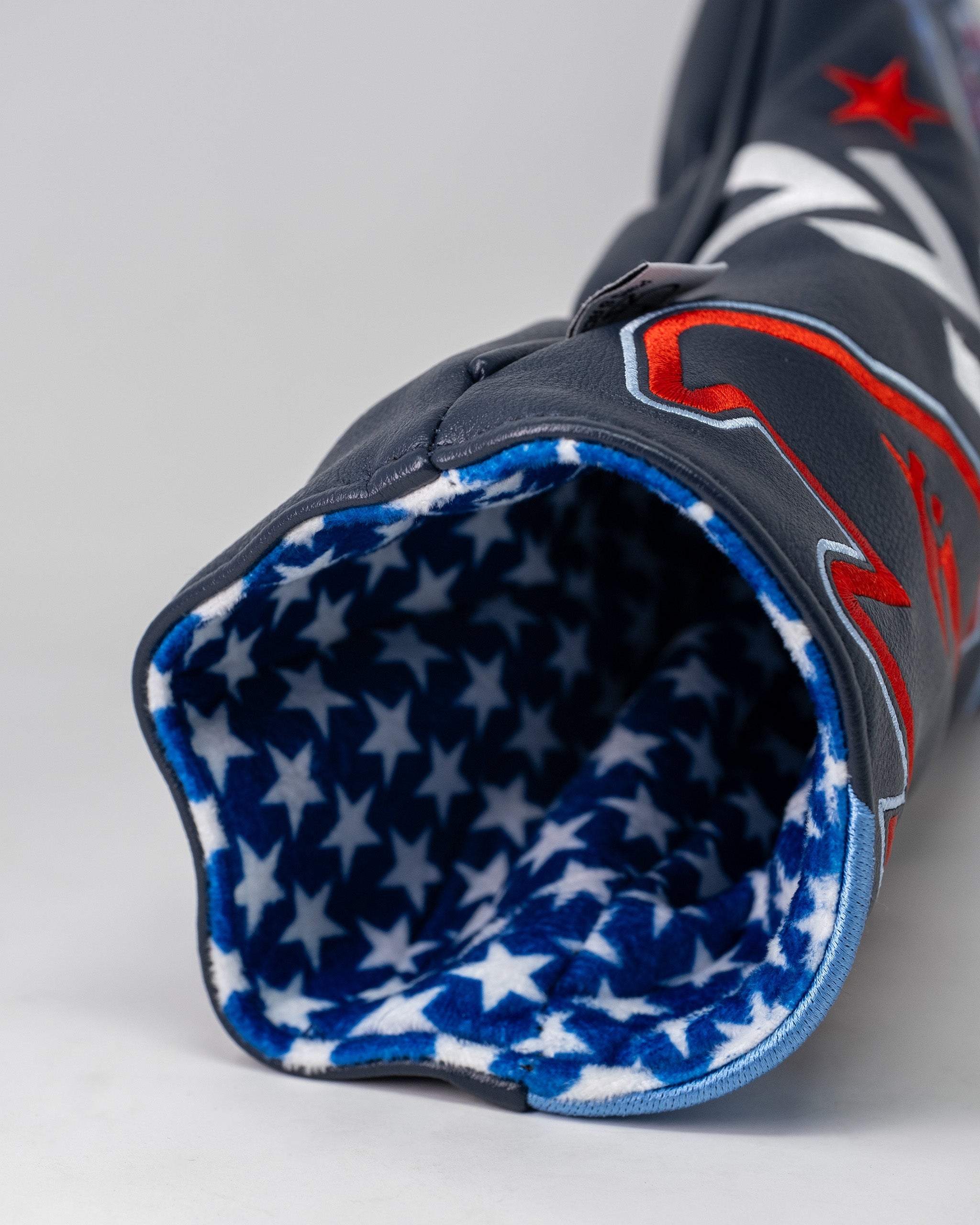 Top Gun Maverick Driver Headcover with a navy exterior, red and white accents, and a blue star-patterned fleece lining.