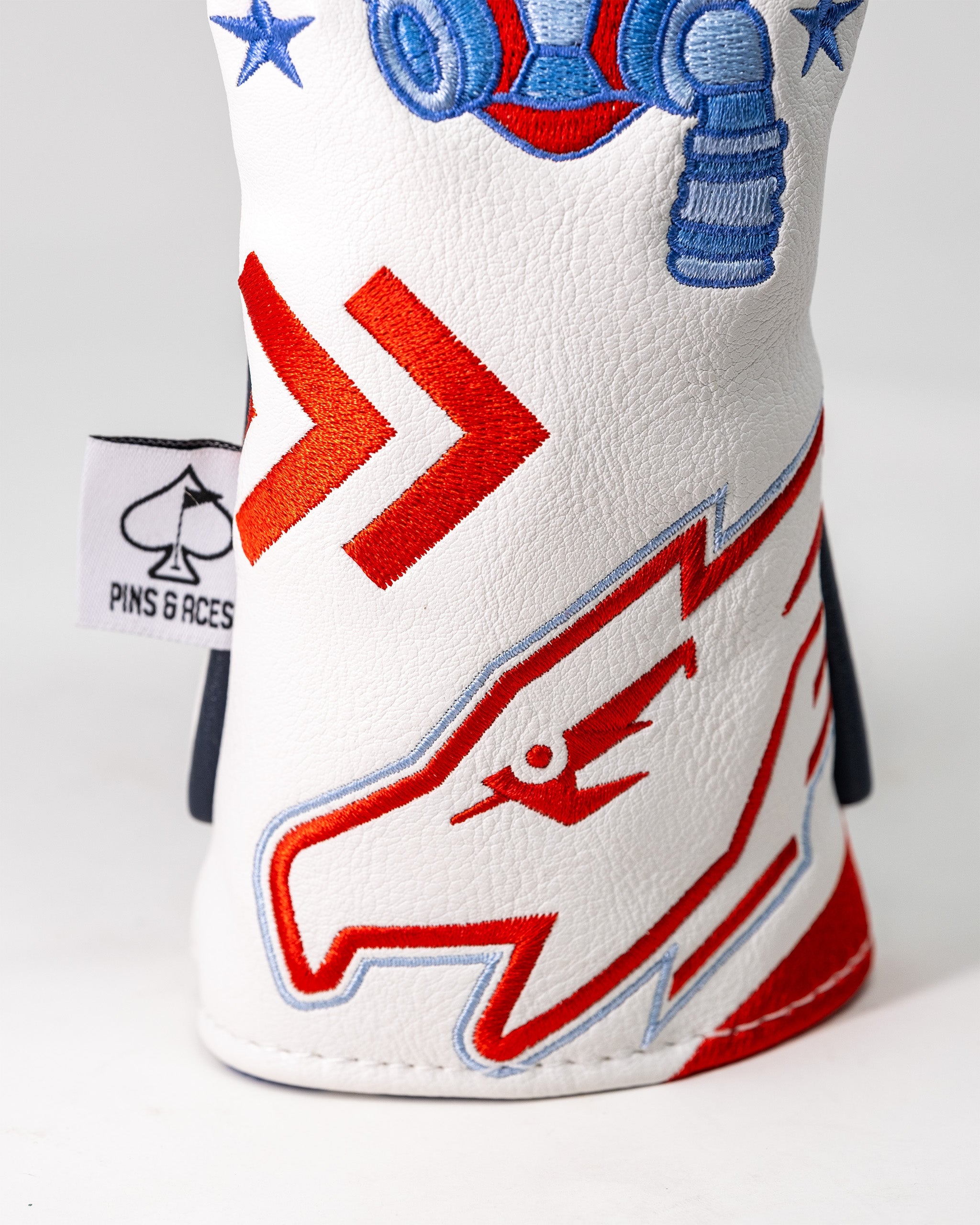 Embroidered Top Gun Goose themed golf headcover with red, blue, and white details and a spade logo tag.