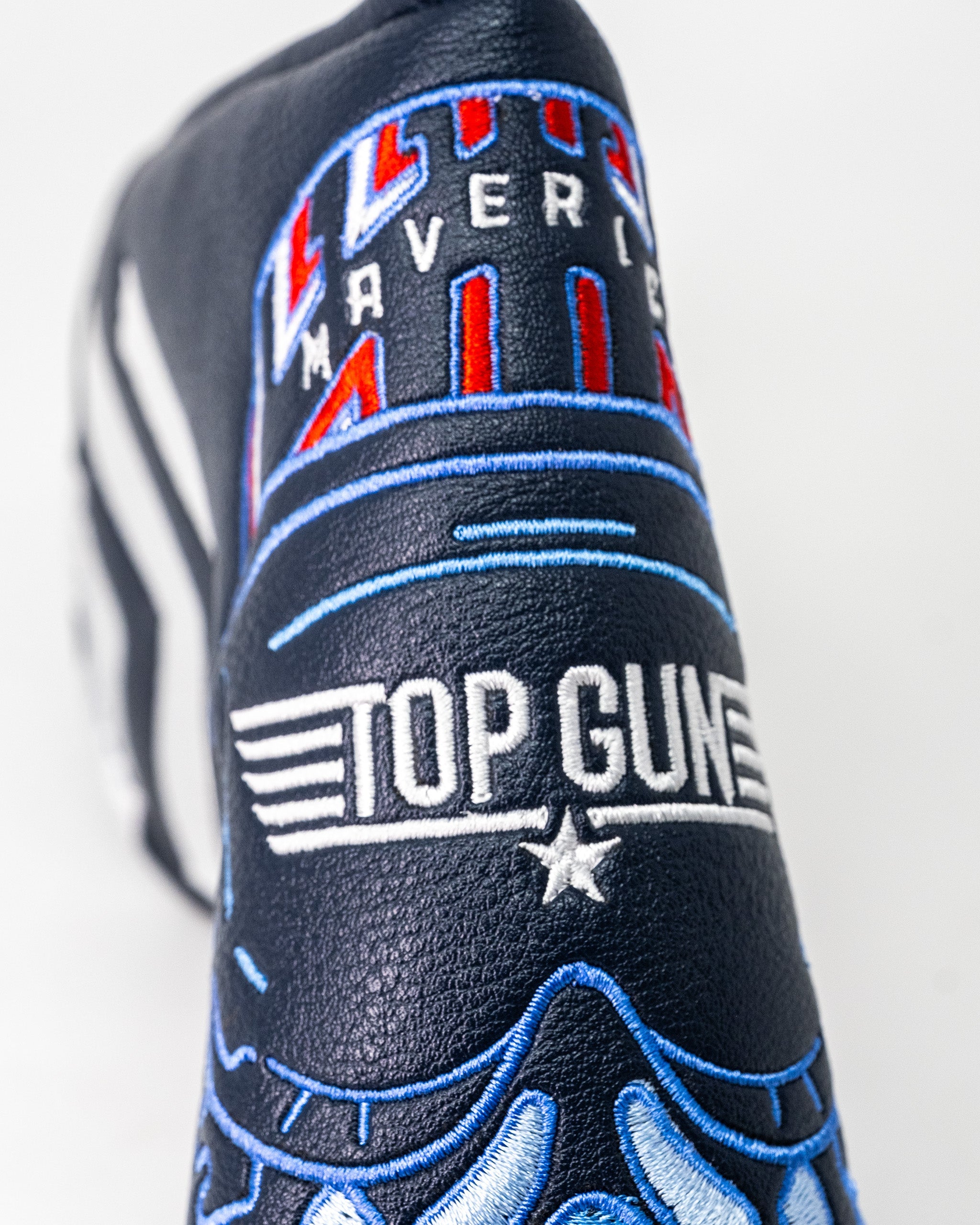 Close-up of a Top Gun Maverick Blade Headcover with embroidered logos and designs in navy, red, white, and blue.