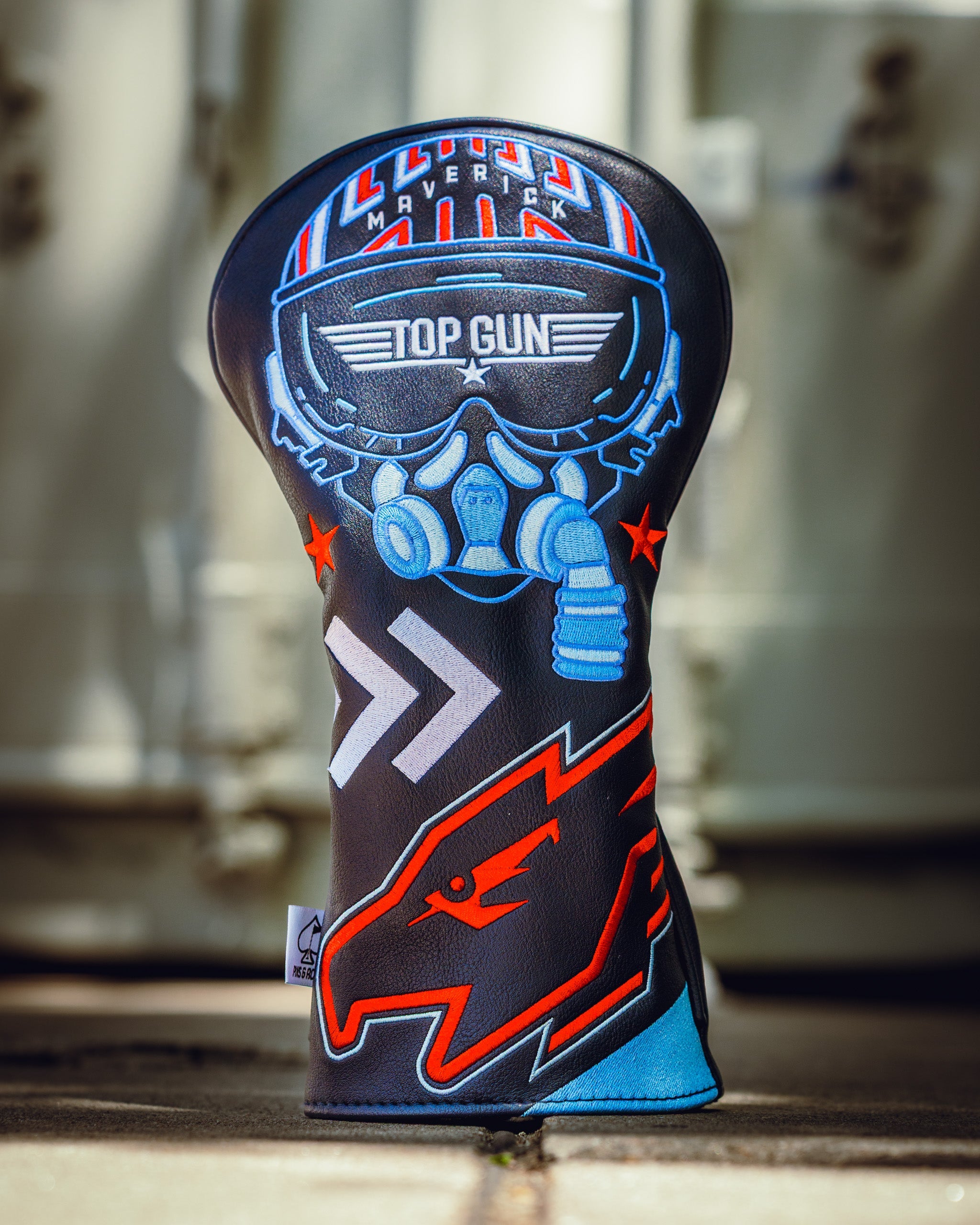 Golf driver headcover featuring a Top Gun Maverick design with a pilot helmet, goggles, and bold graphics in blue, red, and black.