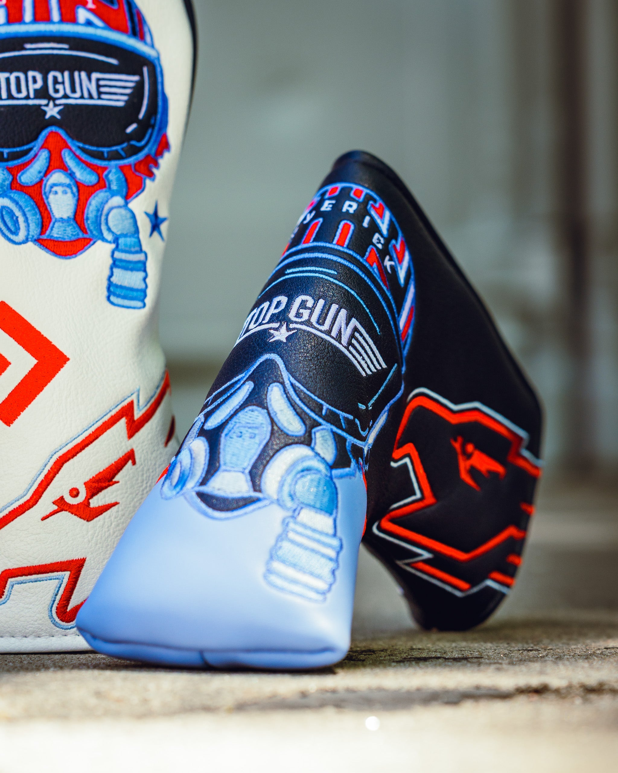 Top Gun Maverick blade headcover featuring a blue and black design with aviation-themed graphics and the Top Gun logo.