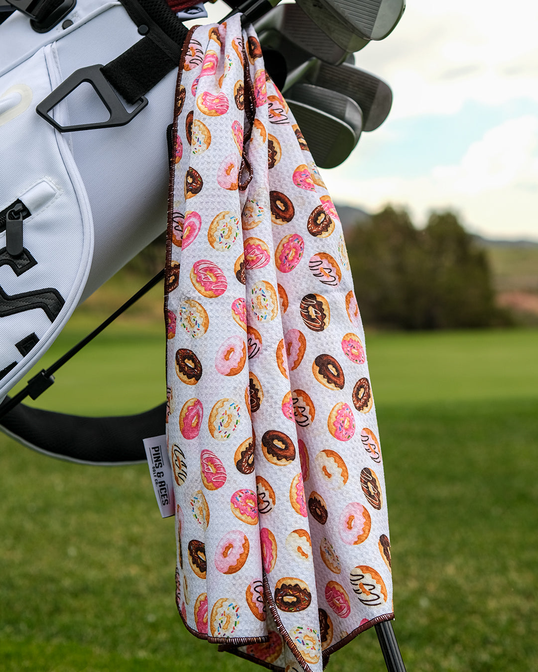 Colorful donut-shaped towel with sprinkles, perfect for beach or bathroom use.