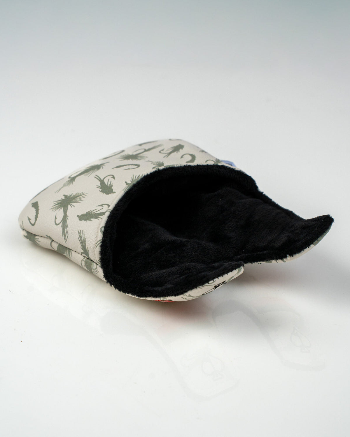 Trout center shaft mallet putter cover featuring a stylish fish pattern and soft black interior for protection.