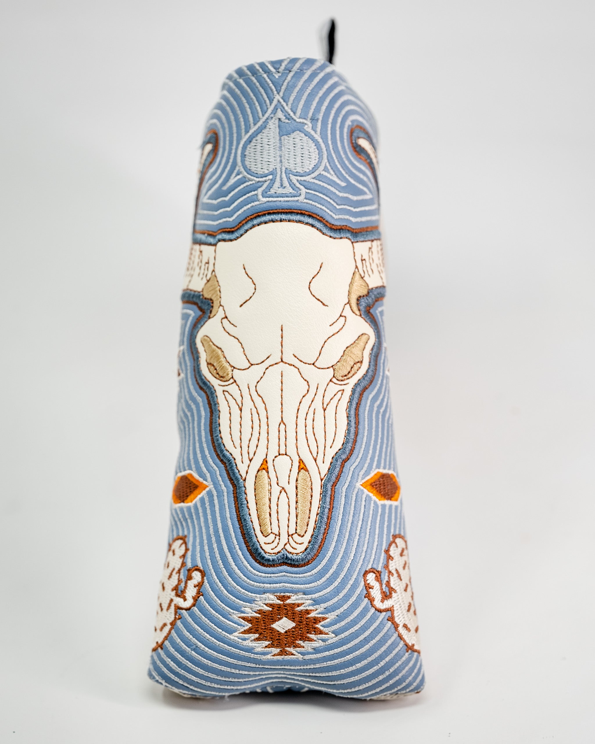 Western Aesthetic Blade Putter Cover featuring intricate embroidery of a skull, hands, and geometric patterns in blue, beige, and orange.