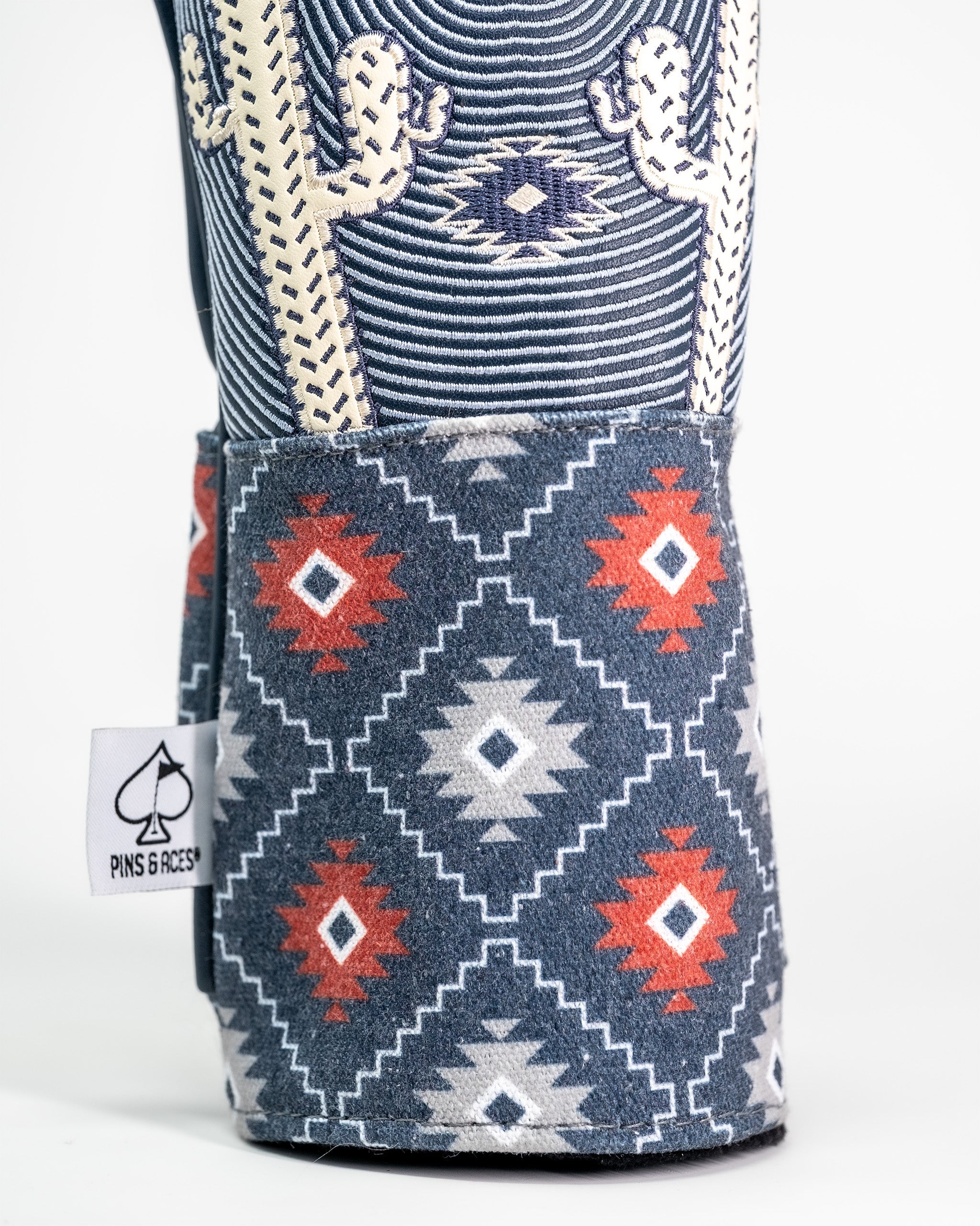 Western aesthetic golf fairway cover with a southwestern-inspired geometric pattern in navy, red, white, and beige.