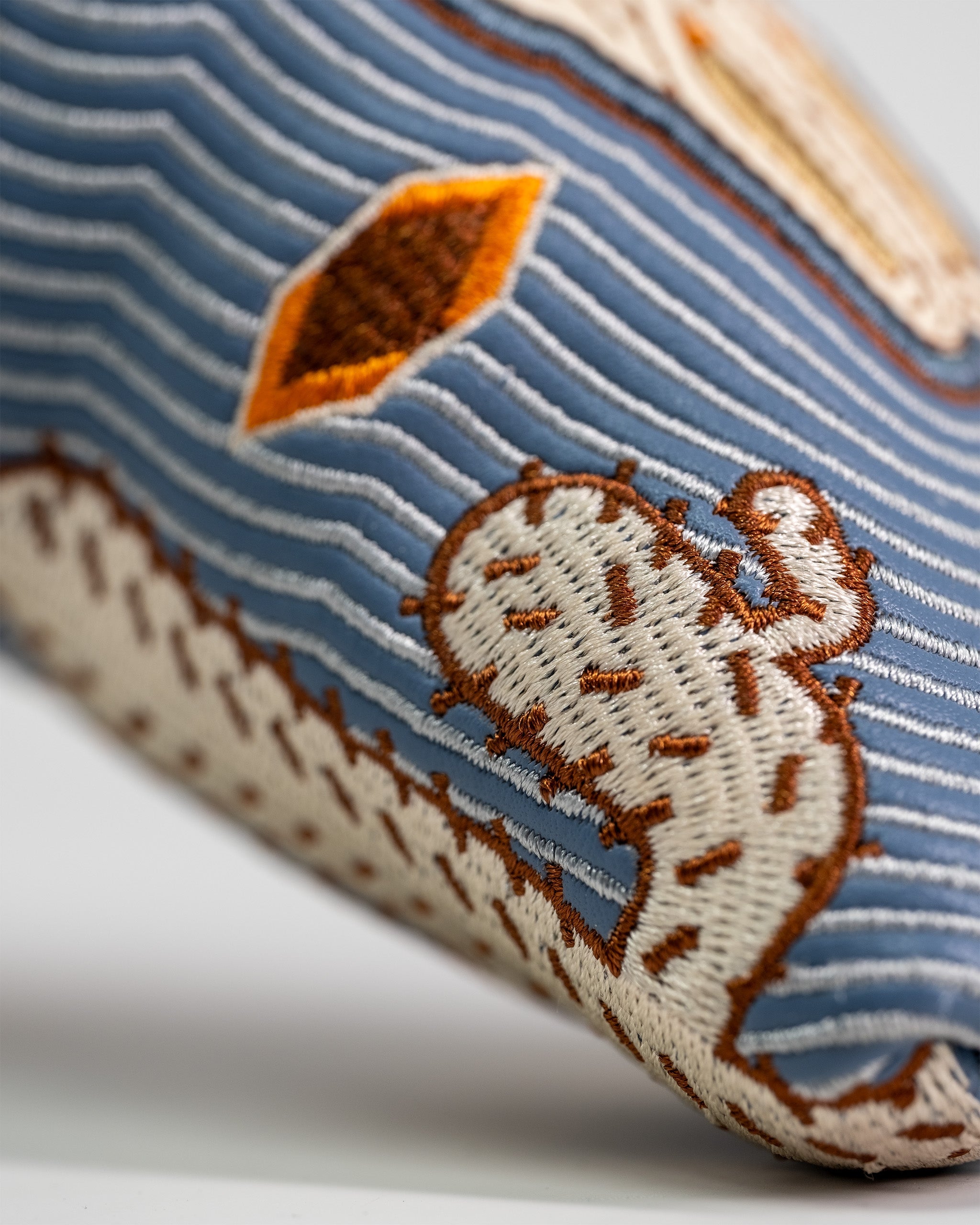 Western Aesthetic Blade Putter Cover featuring embroidered desert landscape and striped design in earthy tones.