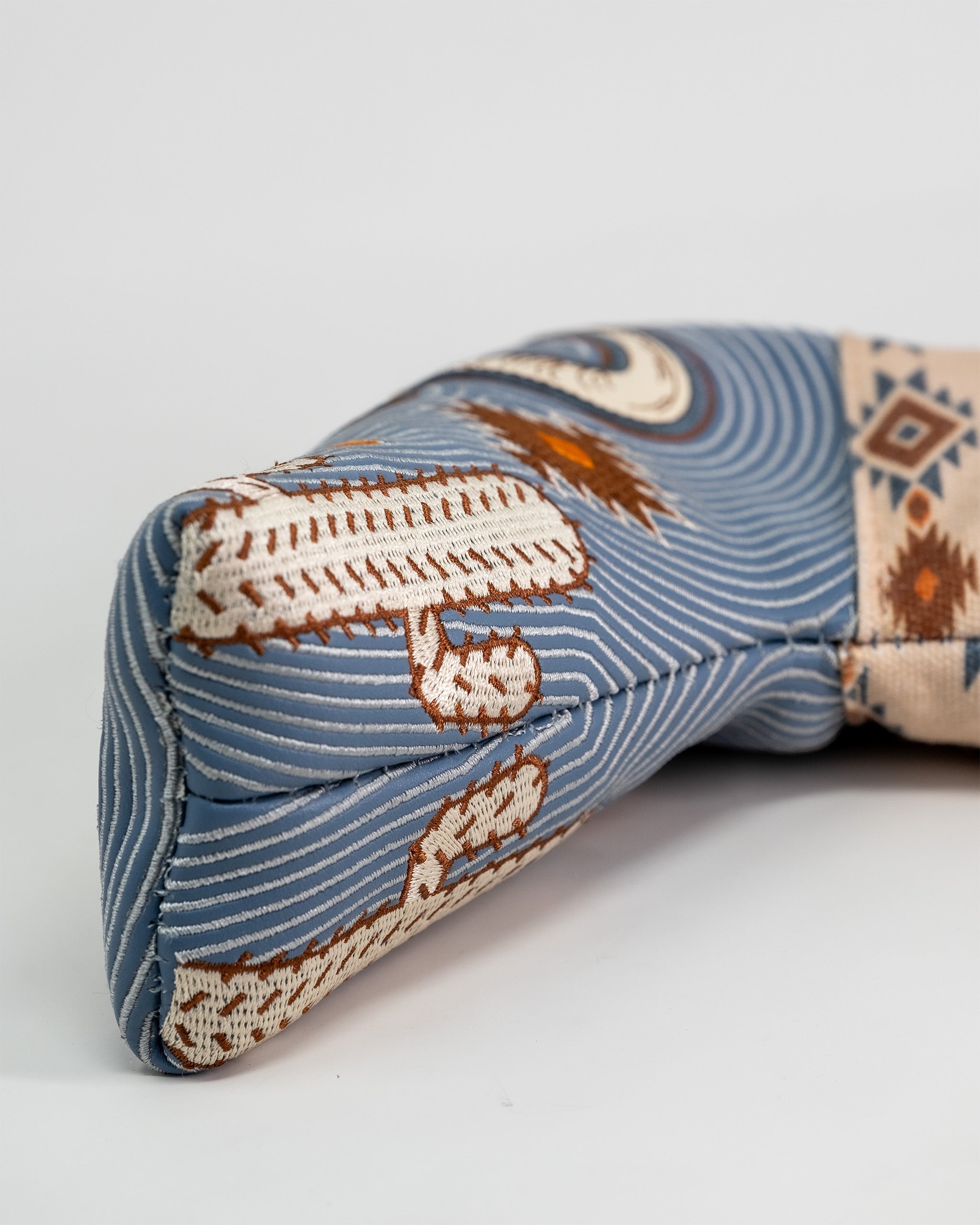Western Aesthetic Blade Putter Cover with a southwestern-inspired embroidered design and striped fabric pattern.